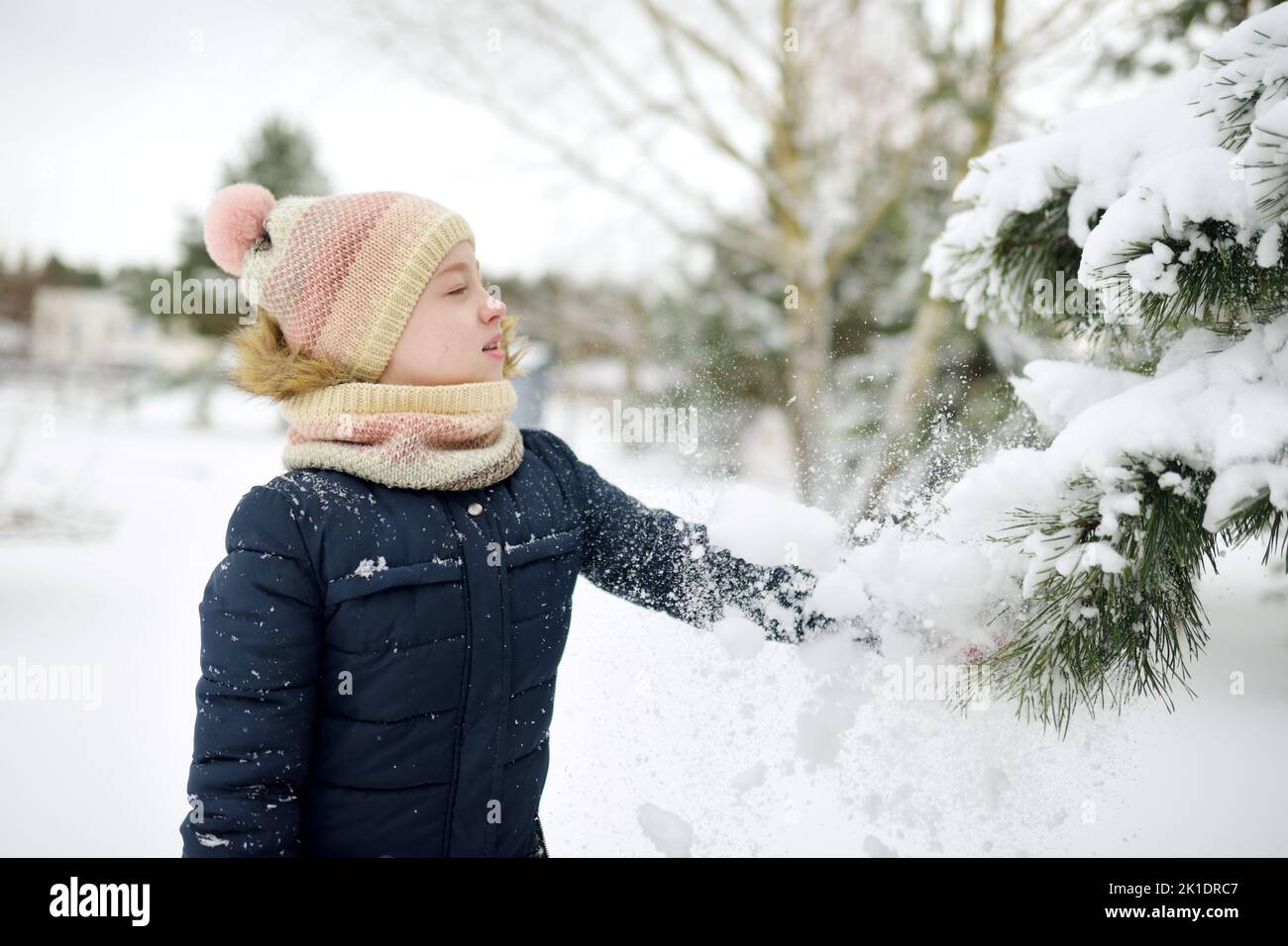 Cute Young Girl Having Fun On A Walk In Snow Covered Park On Chilly cute-young-girl-having-fun-on-a-walk-in-snow-covered-park-on-chilly
