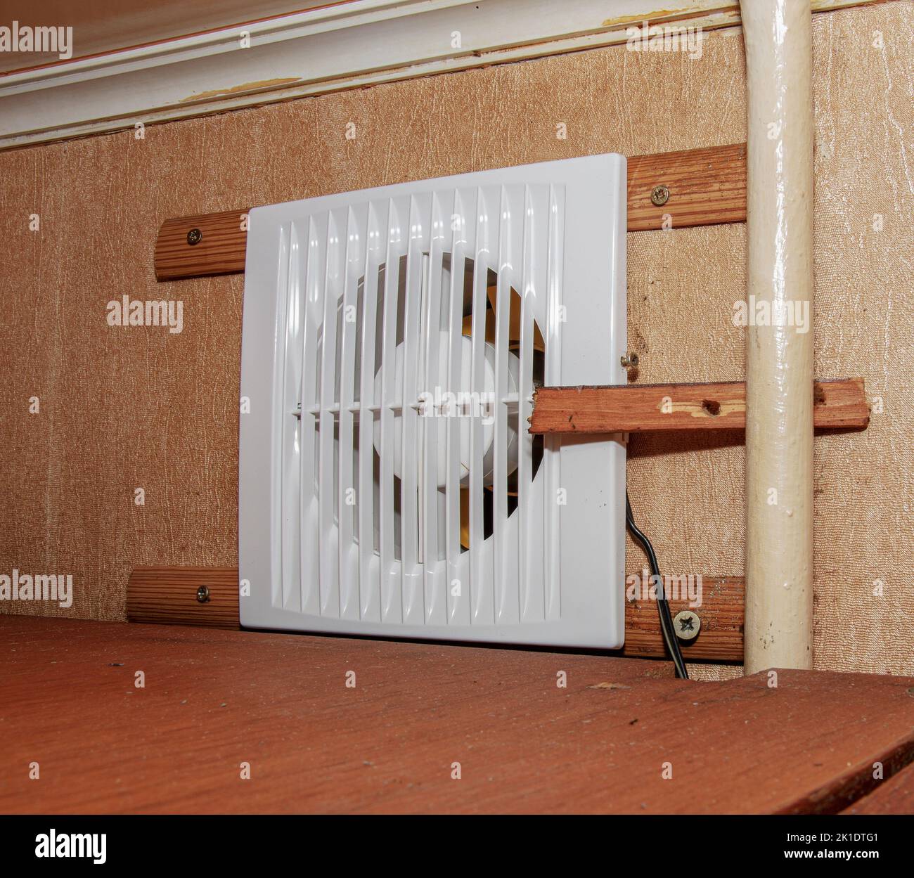 The kitchen exhaust fan after cleaning and washing is installed on the