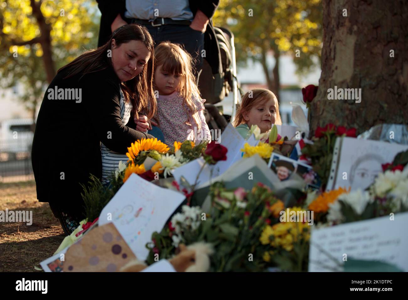 London, UK. 17th Sep, 2022. Mrs Spencer with her two daughters Esther age 4 and sister Phoebe age 7 looks at tributes at St. James park, following the death of Britain's Queen Elizabeth in London, Britain, September 17, 2022 (Credit Image: © May James/ZUMA Press Wire) Stock Photo