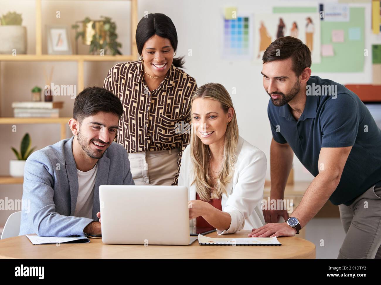 Designer, collaboration and business meeting working on laptop for