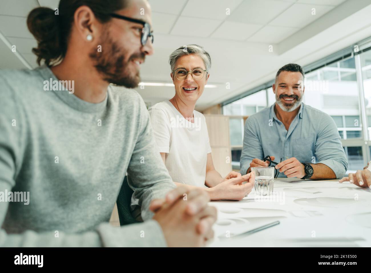 Cheerful architects smiling happily while during a meeting in a modern