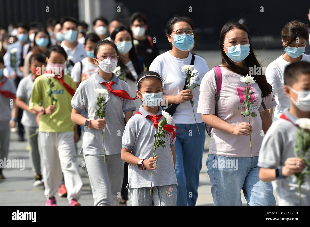 NANJING, CHINA - SEPTEMBER 18, 2022 - People hold flowers as they visit the Memorial Hall of the Victims of the Nanjing Massacre by Japanese Invaders Stock Photo