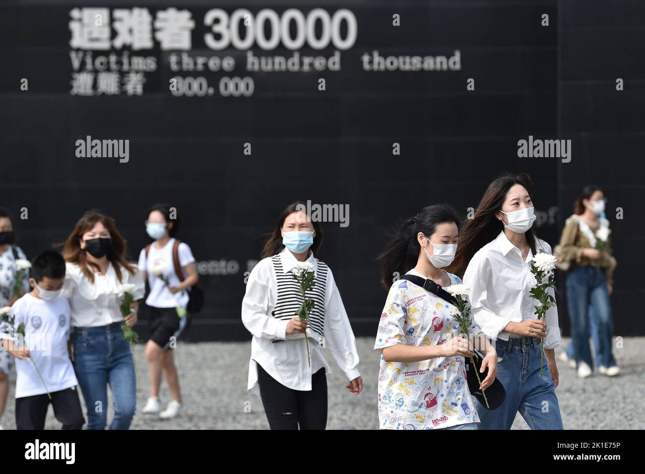 NANJING, CHINA - SEPTEMBER 18, 2022 - People hold flowers as they visit the Memorial Hall of the Victims of the Nanjing Massacre by Japanese Invaders Stock Photo