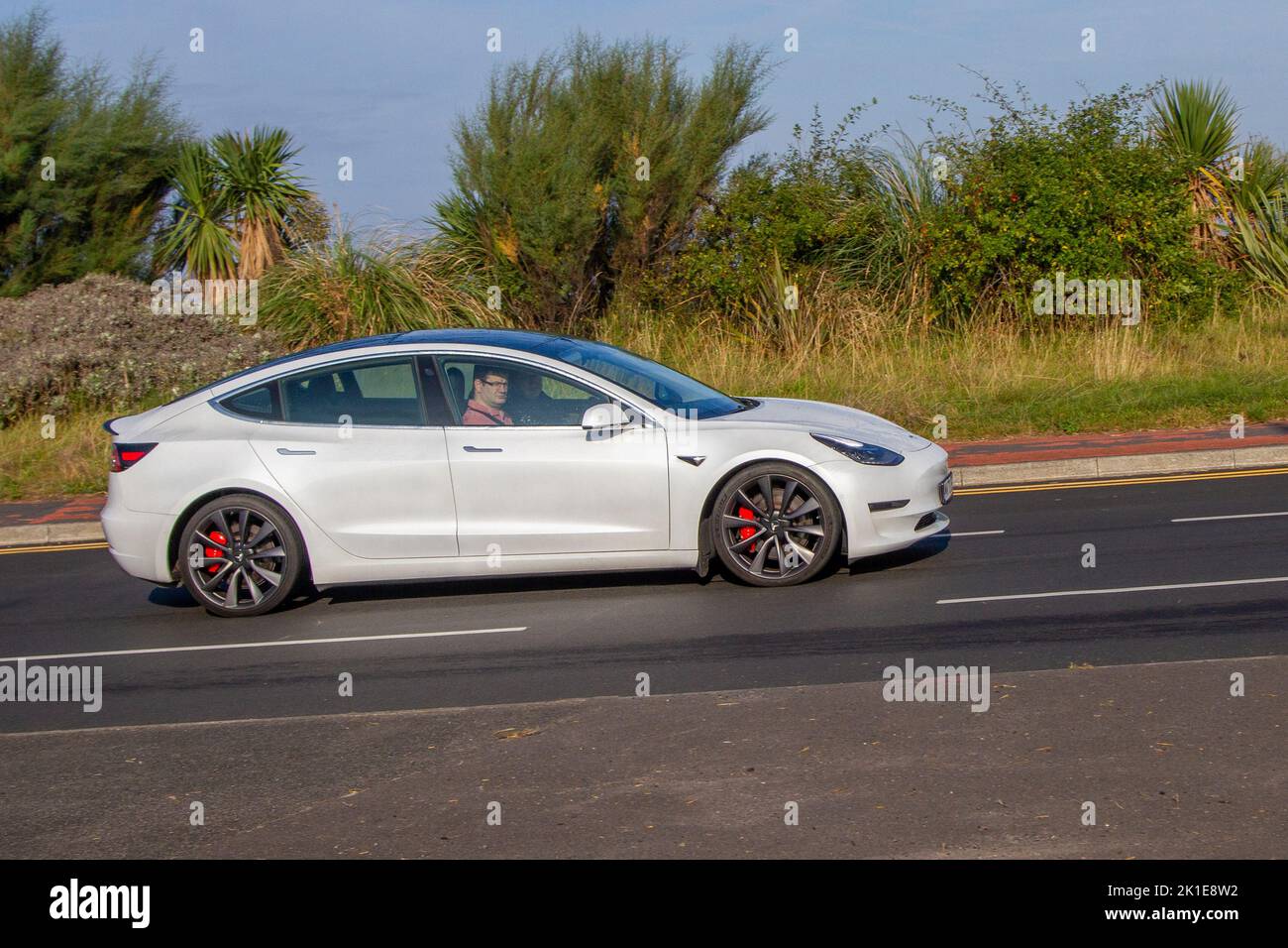 2020 White TESLA Model 3 PERFORMANCE AWD 1 speed automatic Electricity travelling in Southport, UK Stock Photo