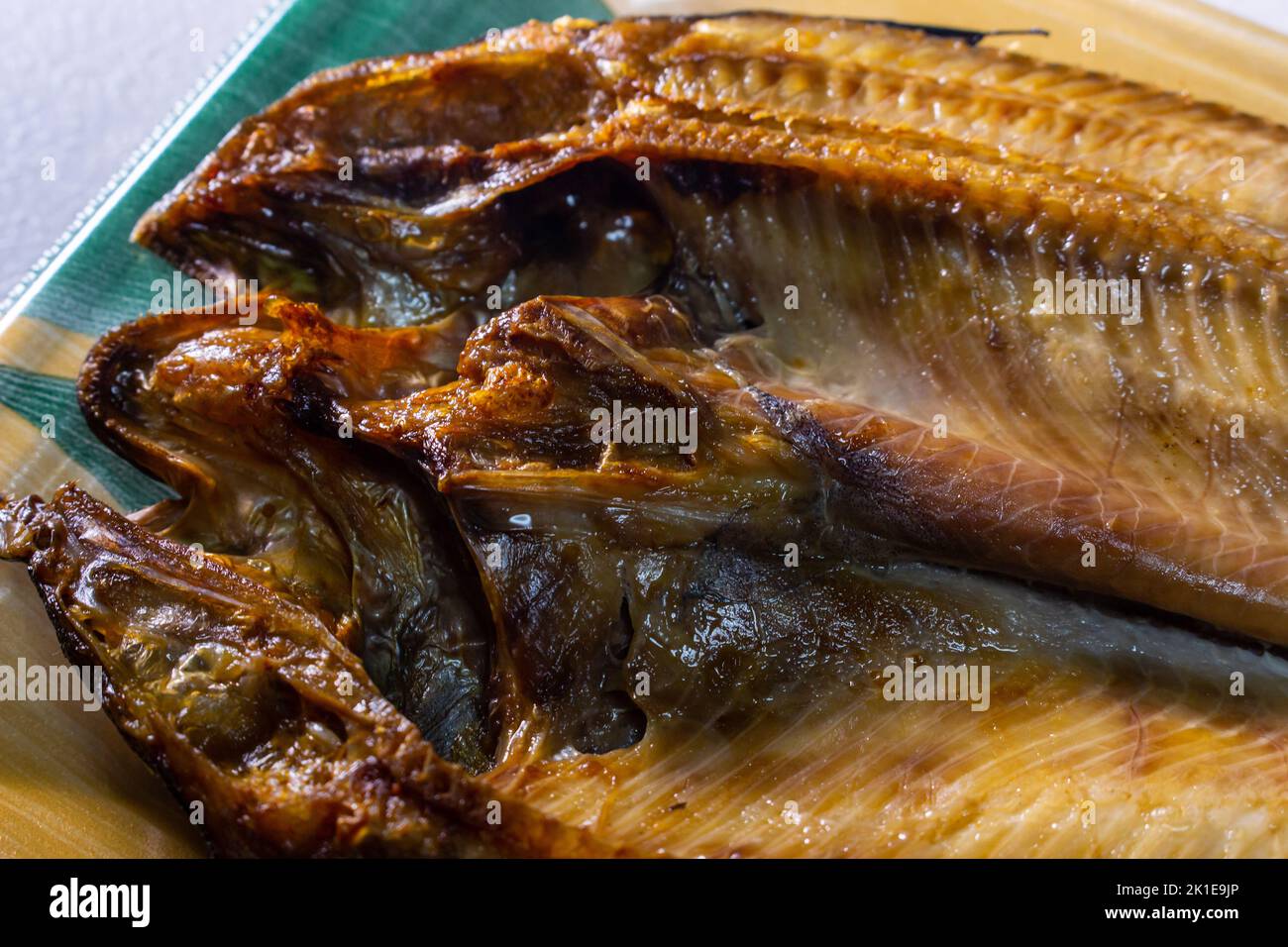 Closeup Japanese Aji no Hiraki (dried and salted horse mackerel) in a food container. Stock Photo