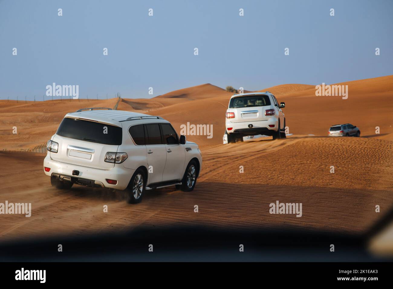 Dubai, United Arab Emirates - 01, July 2021 : Race in sand desert. Competition racing challenge desert. Car drives offroad with clouds of dust. Offroad vehicle racing with obstacles in wilderness Stock Photo