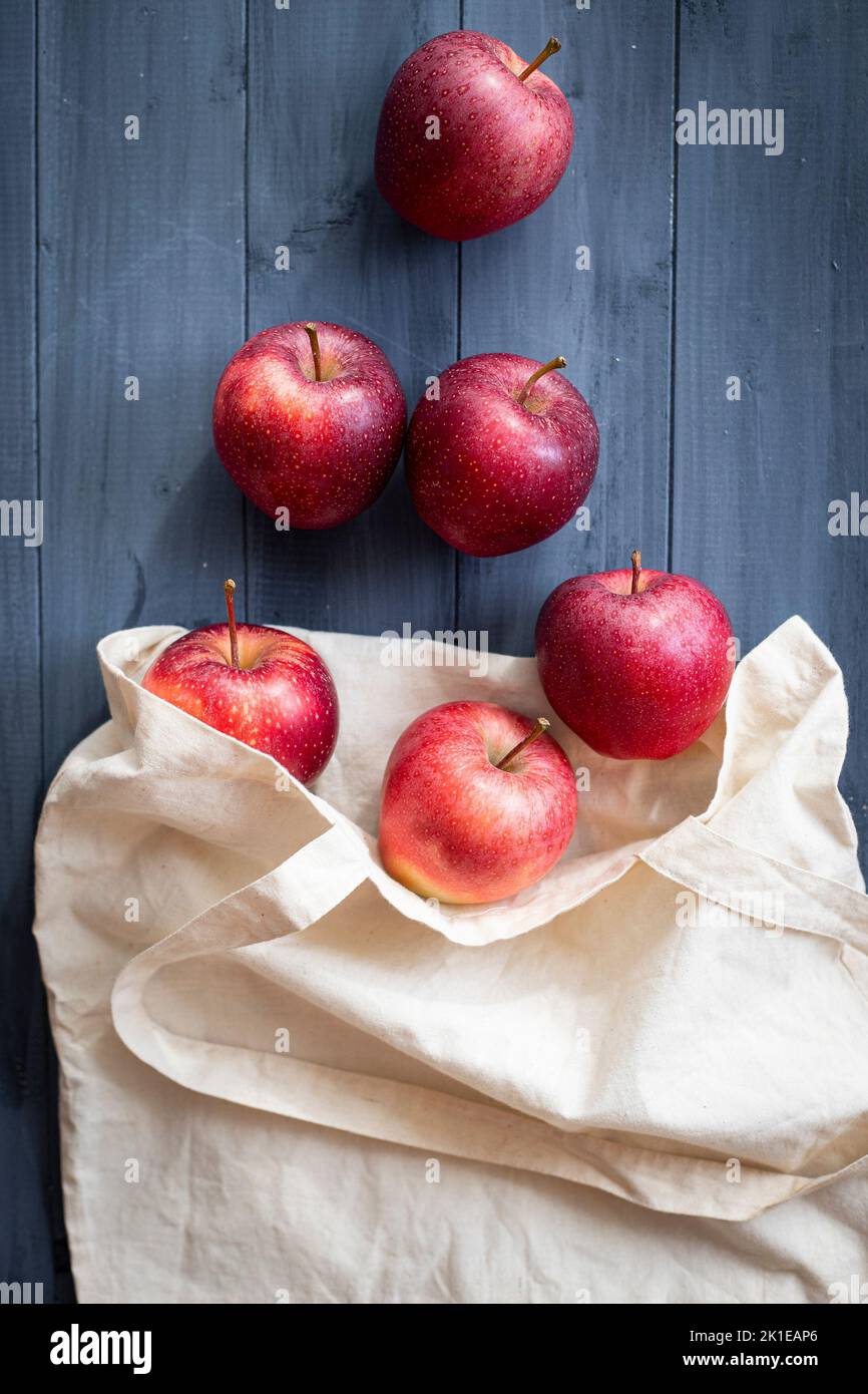 Apple fruit in plastic bag on wood table Stock Photo by ©jannystockphoto  77413662