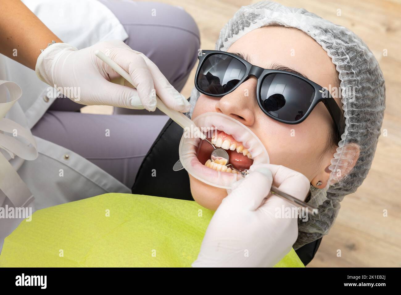 Dentist Examining Patient's Mouth with dental mirror In Clinic Stock ...