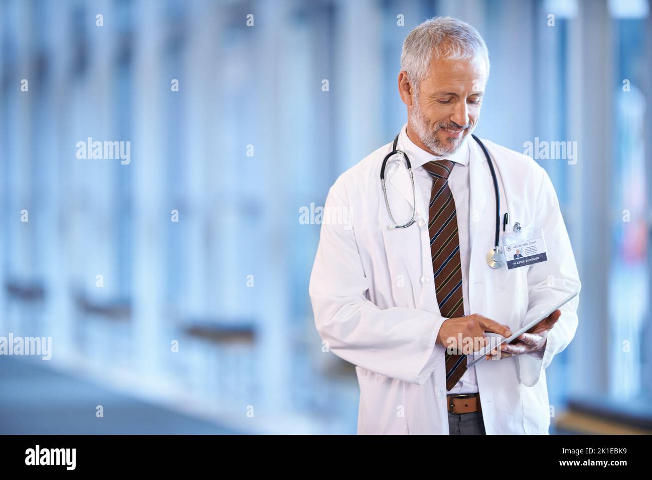 Making a diagnosis. a mature doctor holding a patient file in a ...
