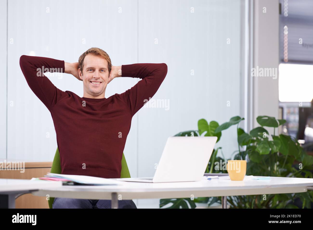 Feeling relaxed about work. A handsome businessman working at his desk. Stock Photo