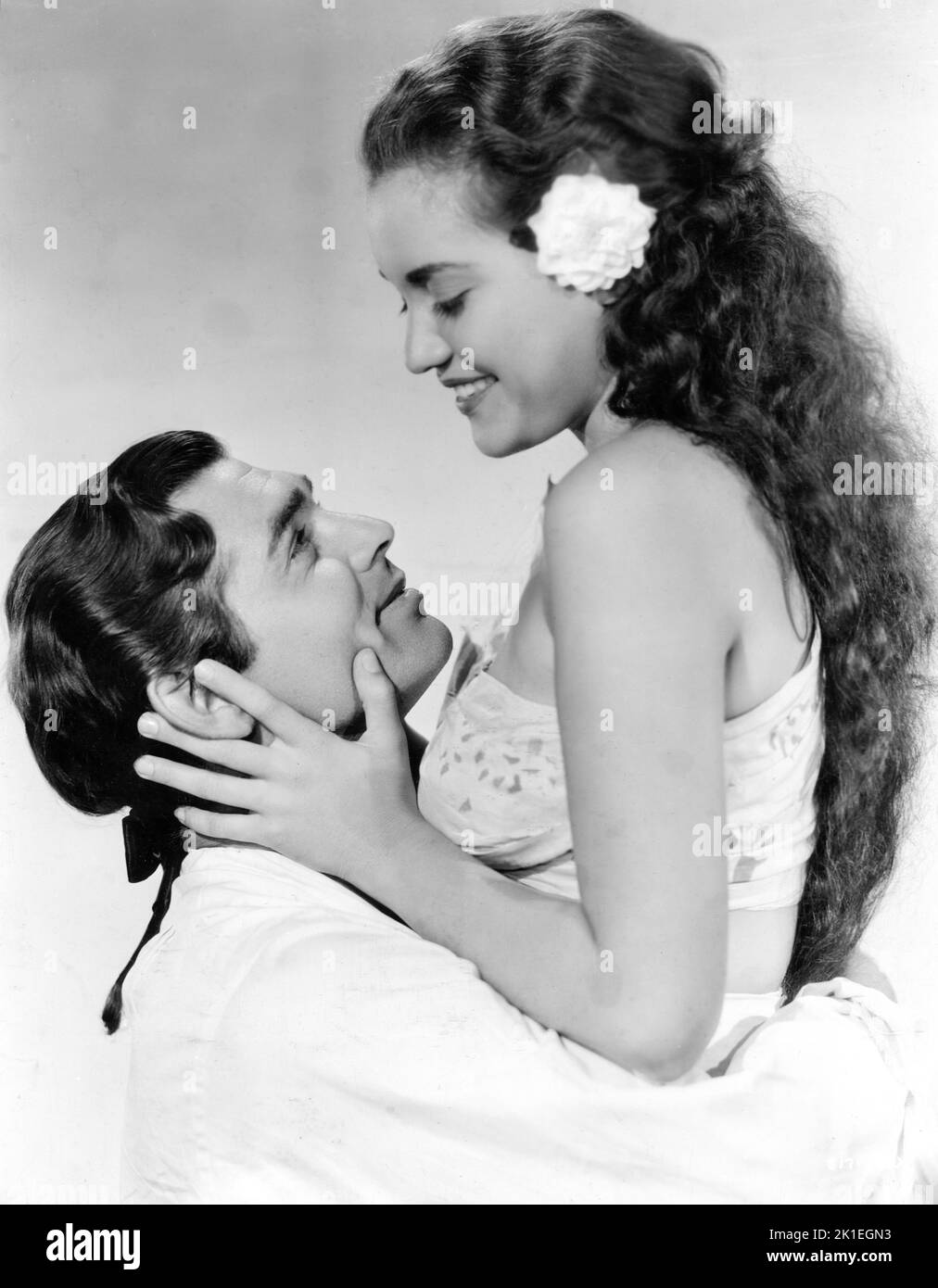 CLARK GABLE as Fletcher Christian and MAMO CLARK as Maimiti Posed Publicity Portrait in MUTINY