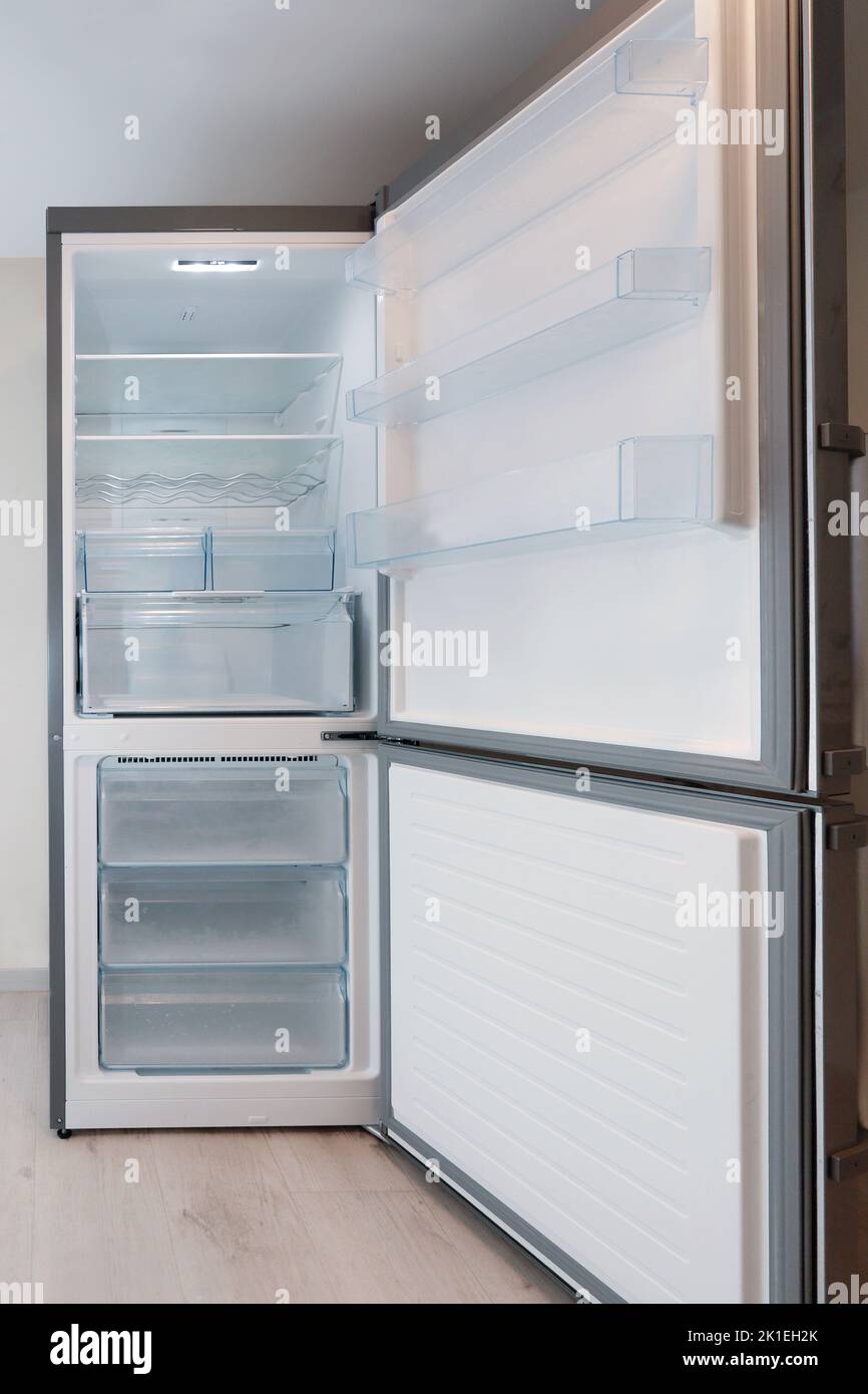 empty refrigerator with doors open at home Stock Photo