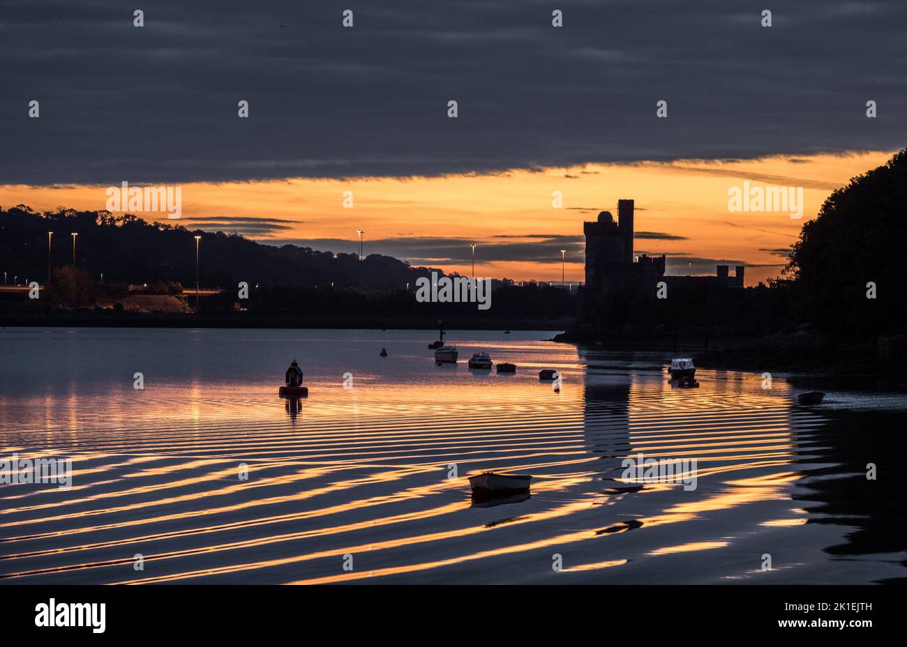 Blackrock, Cork, Ireland. 18th September, 2022. Ripples generated by a passing boat are caught in dawn light at Blackrock, Cork, Ireland. - Credit; David Creedon / Alamy Live News Stock Photo