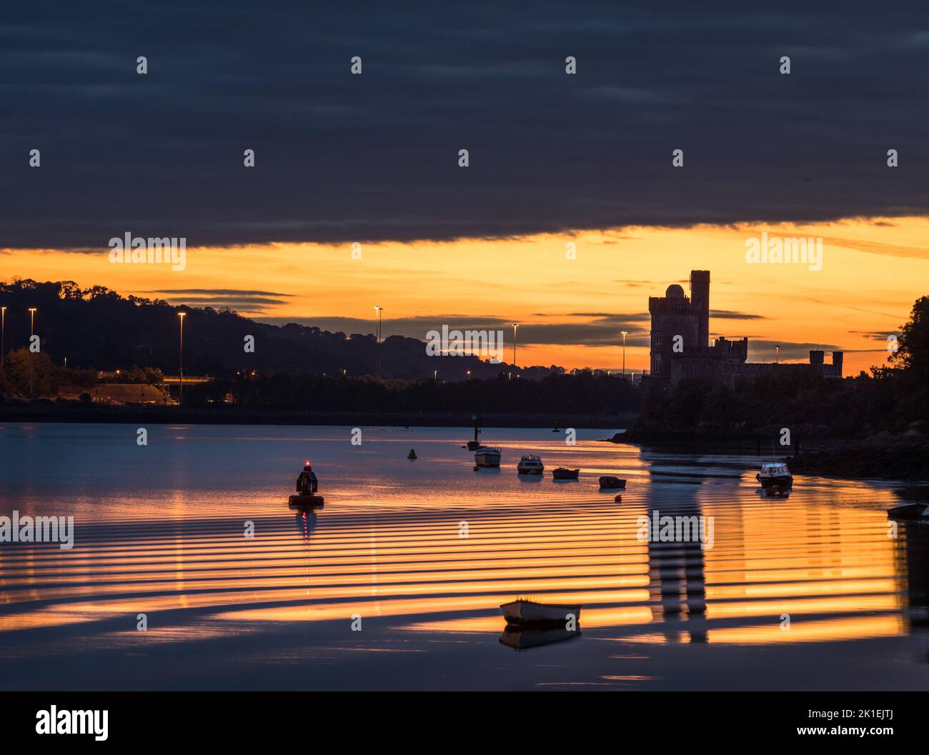 Blackrock, Cork, Ireland. 18th September, 2022. Ripples generated by a passing boat are caught in dawn light at Blackrock, Cork, Ireland. - Credit; David Creedon / Alamy Live News Stock Photo