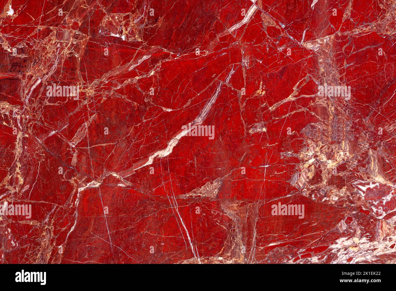 Red Jasper. Gemstone background. Matt natural semi precious mineral pattern. Semiprecious stone texture for ceramic wall and floor digital tiles Stock Photo