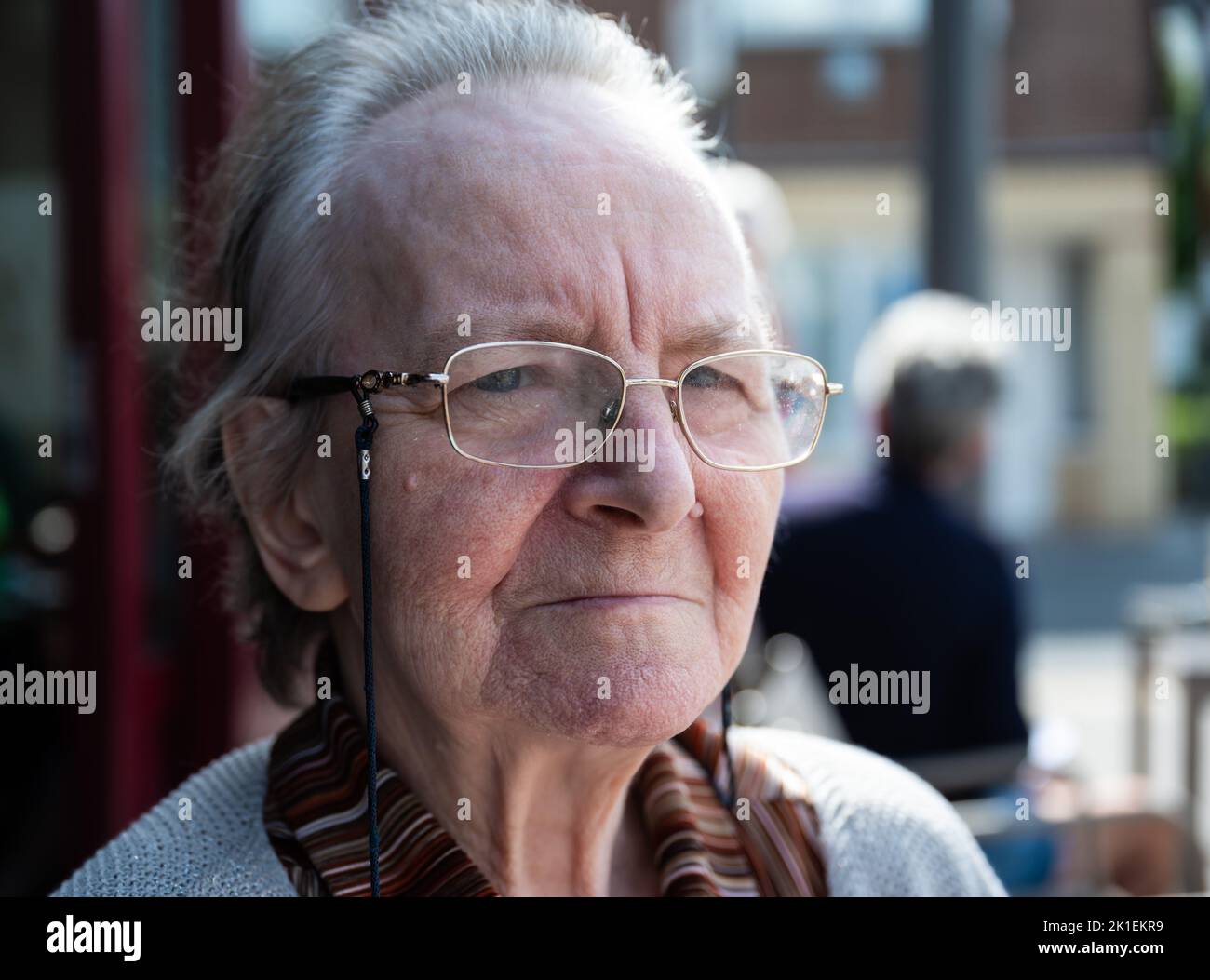 Portrait of a 84 yo grandmother looking with a serious expression, Tienen, Belgium Stock Photo