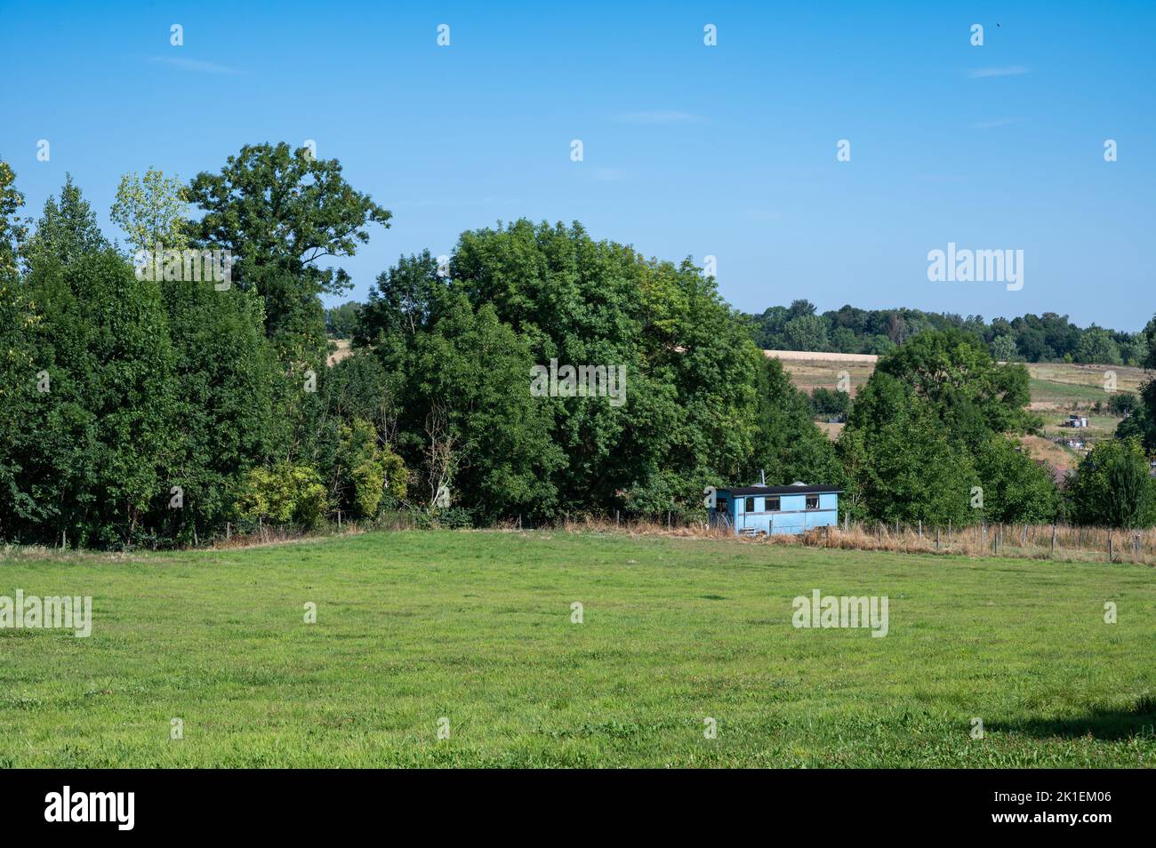 Agriculture fields and trees against blue sky, Hoegaarden, Belgium Stock Photo