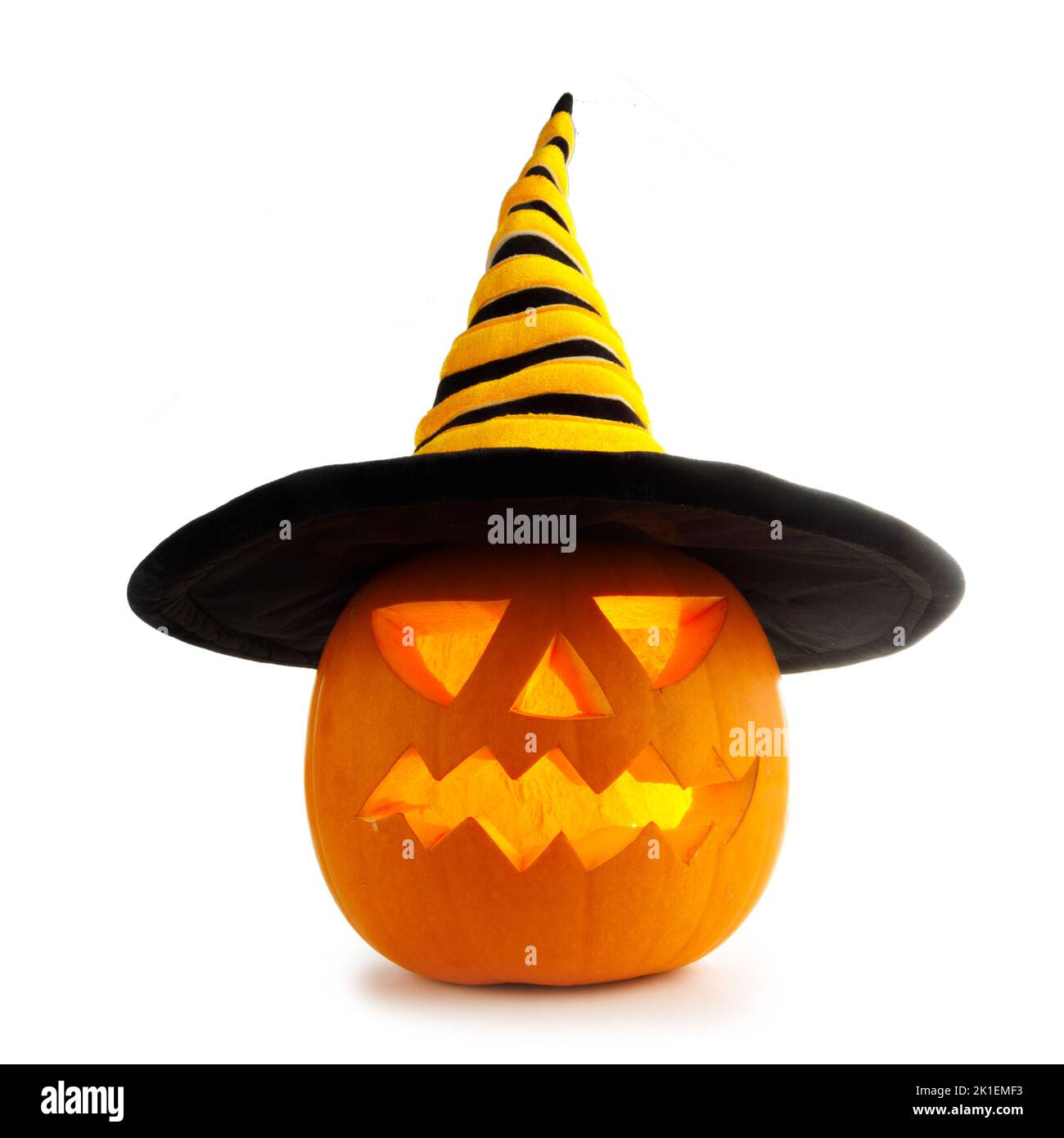 Funny Jack O Lantern Halloween pumpkin wearing witches hat isolated on white background Stock Photo