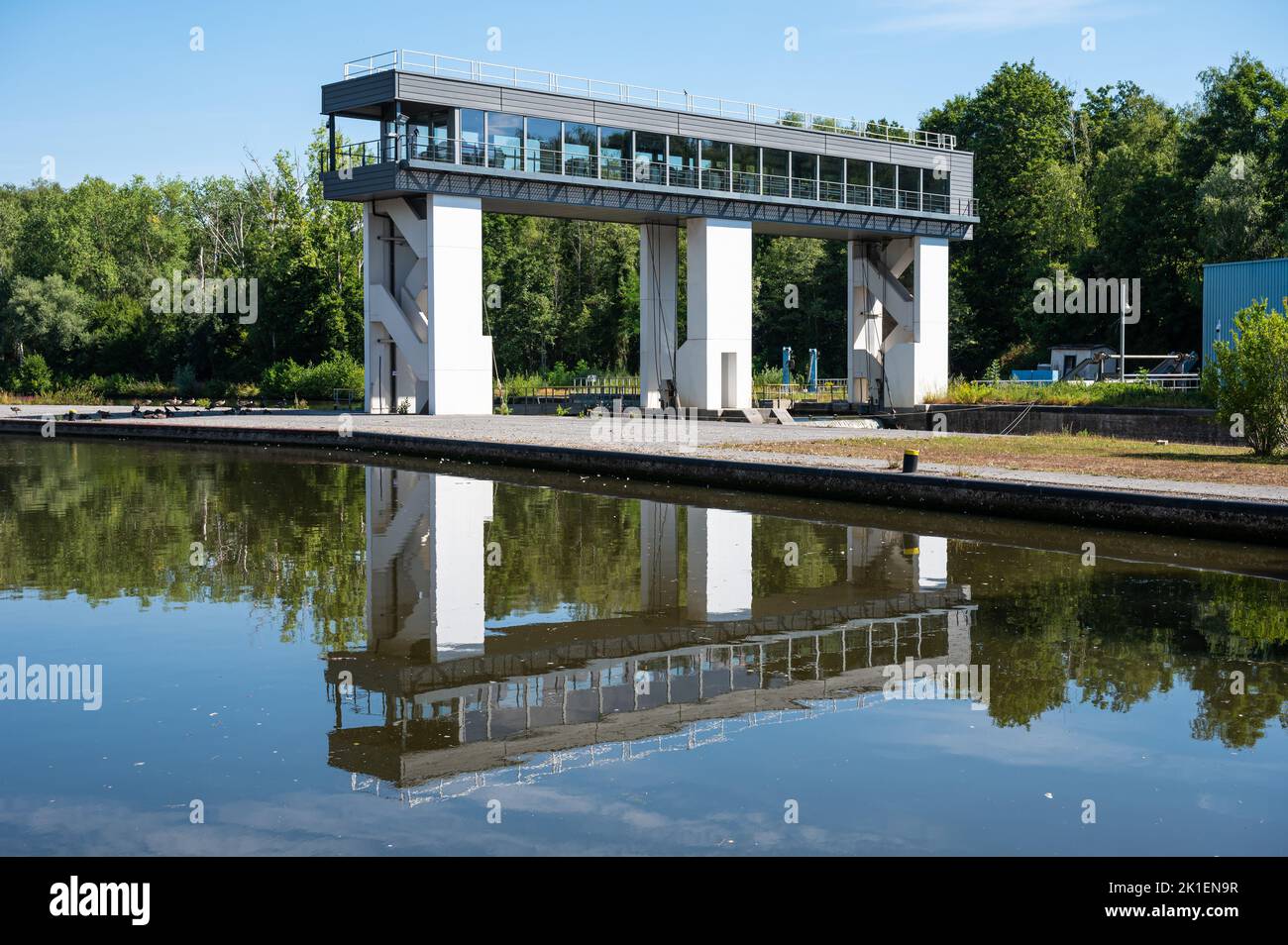 Mornimont, Wallon Region, Belgium, 07 29 2022 - The sluice bridge reflecting in the water of the River Sambre Stock Photo