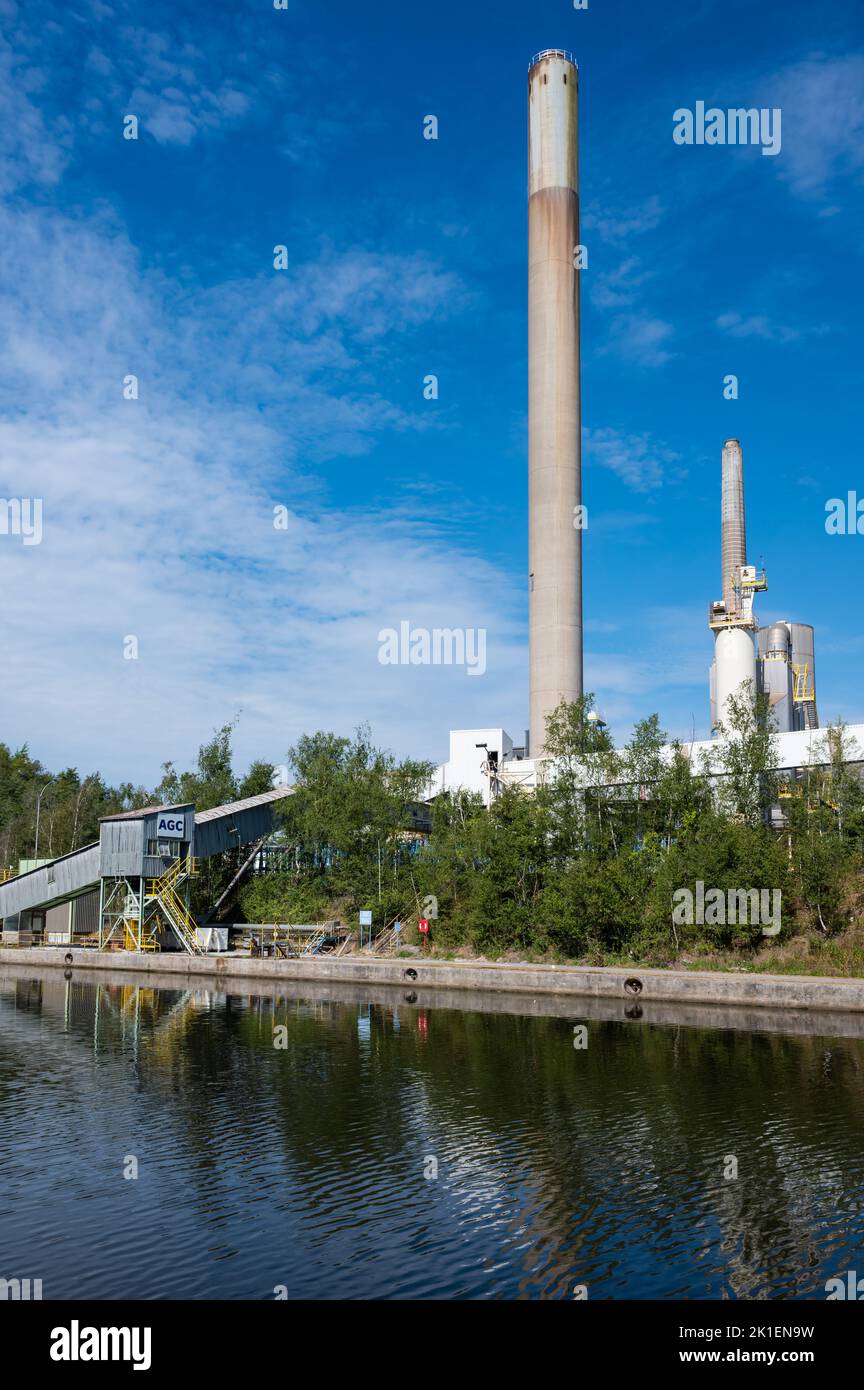 Jemeppe-sur-Sambre, Wallon Region, Belgium, 07 29 2022 - Industrial chimney of the AGC company for the production of glass Stock Photo