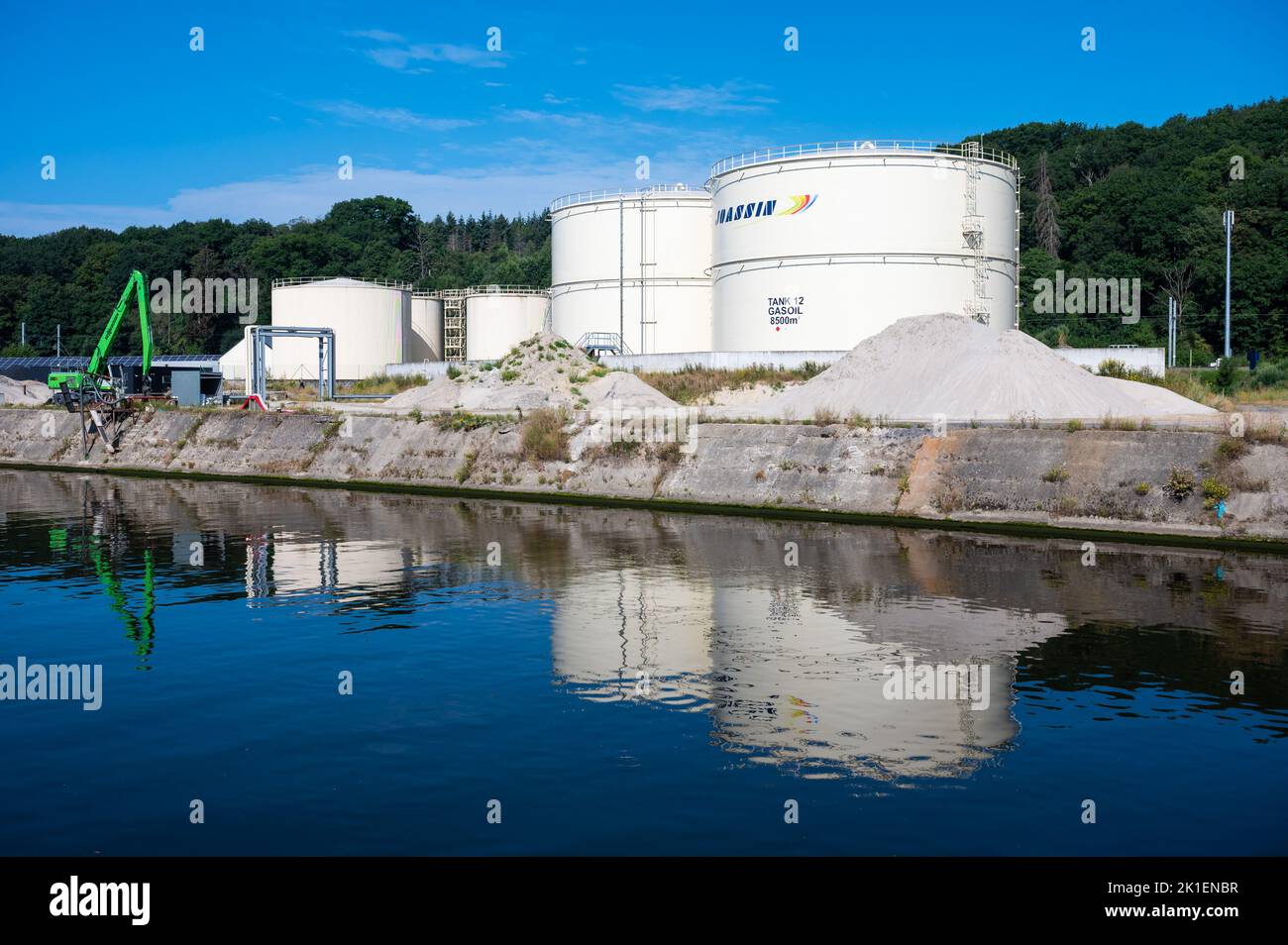 Floreffe, Wallon Region, Belgium, 07 28 2022 - The Joassin gasoiltanks reflecting in the water of the River Sambre Stock Photo