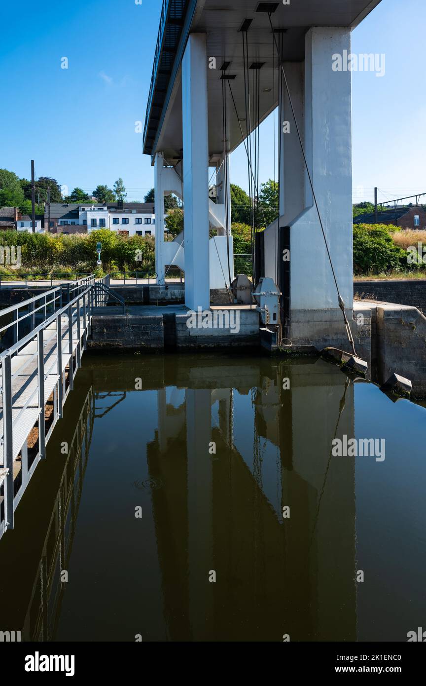 Namur, Wallon Region, Belgium, 07 28 2022 - The city sluice reflecting in the water of the River Sambre Stock Photo