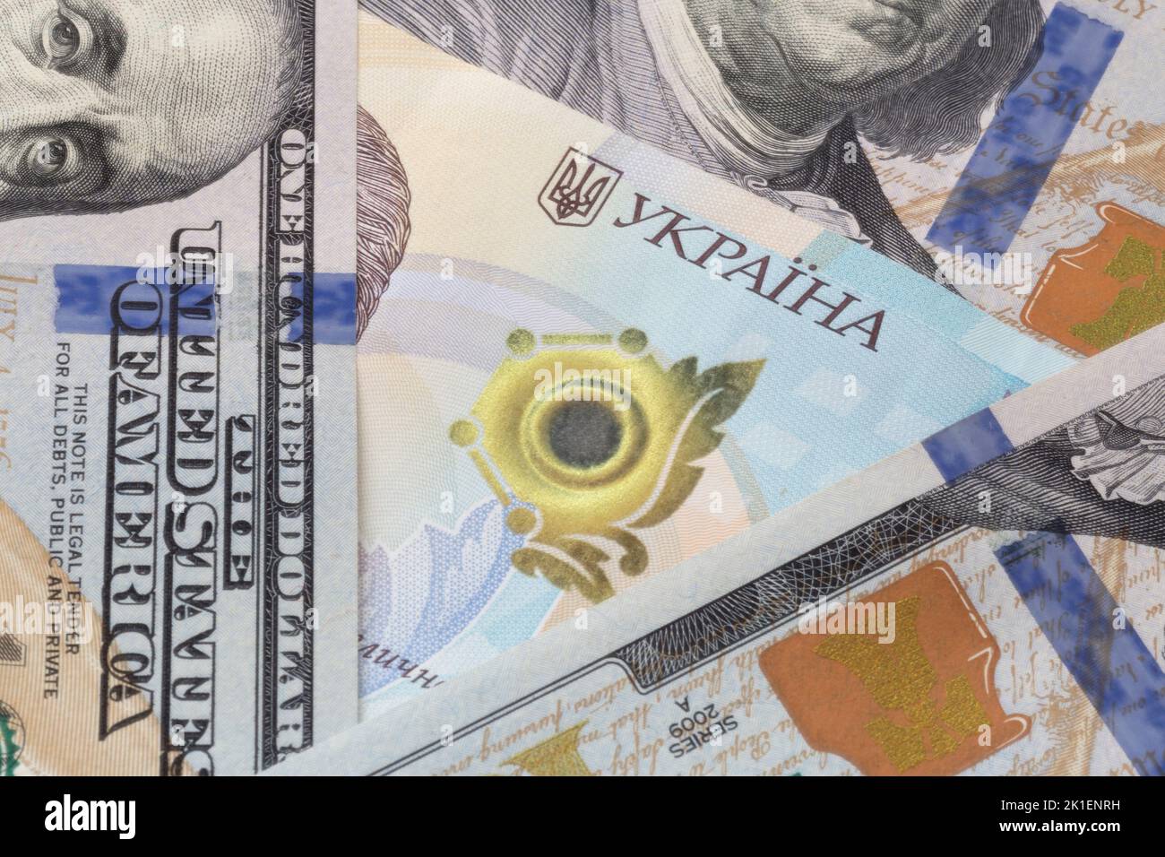 close up of Ukrainian one thousand hrivnya banknote surrounded by US dollars banknotes Stock Photo