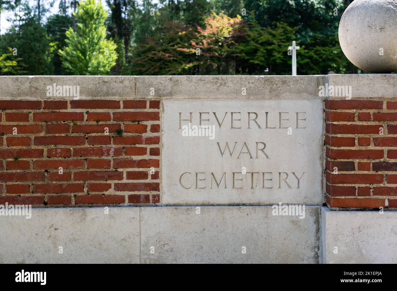 Heverlee, Flemish Brabant, Belgium - 08 21 2022 - Sign of the Heverlee War Cemetery against a brick stone wall Stock Photo