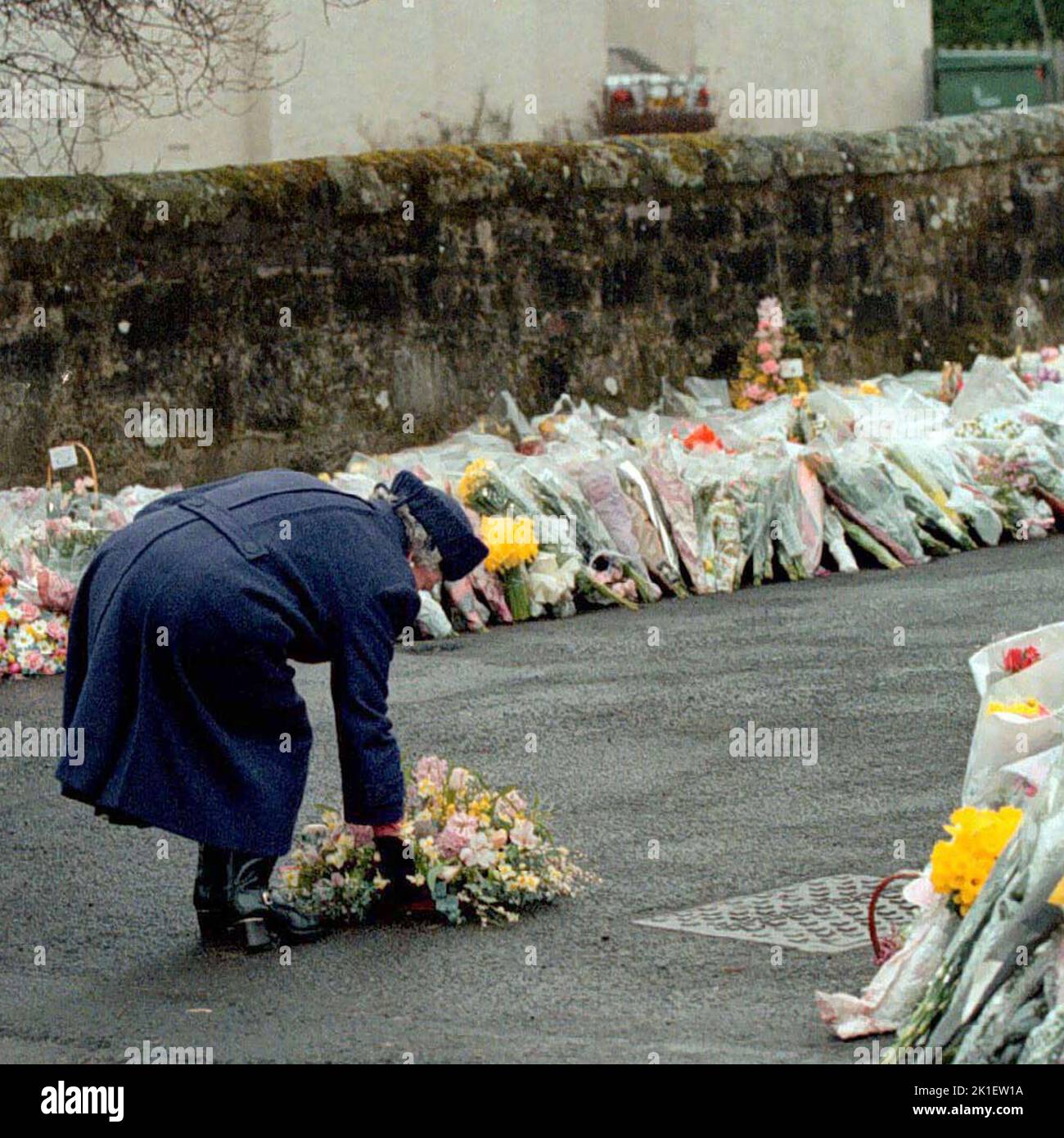 File photo dated 17/03/96 of Queen Elizabeth II laying a wreath at the gates of Dunblane Primary School after one of the deadliest firearms incidents in UK history. Gunman Thomas Hamilton killed sixteen children and one teacher at the school near Stirling, Scotland on 13 March, before committing suicide. Issue date: Sunday September 18, 2022.. Photo credit should read: PA Wire Stock Photo