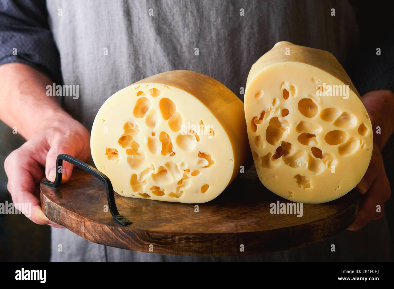 Cheesemaker measuring temperature with thermometer in a large steel tank  full of milk Stock Photo - Alamy