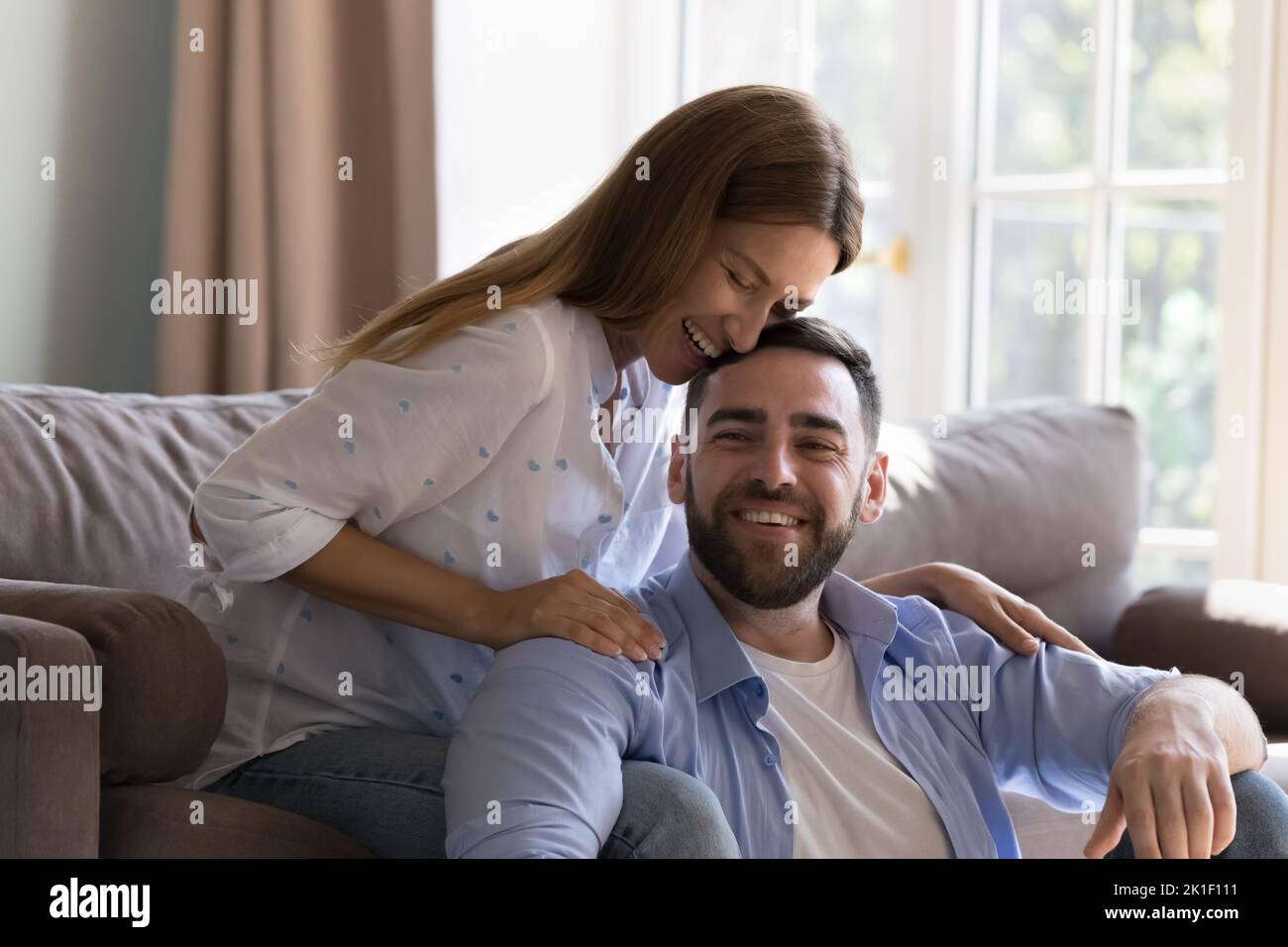 Happy young beautiful woman and handsome man relaxing at home Stock Photo