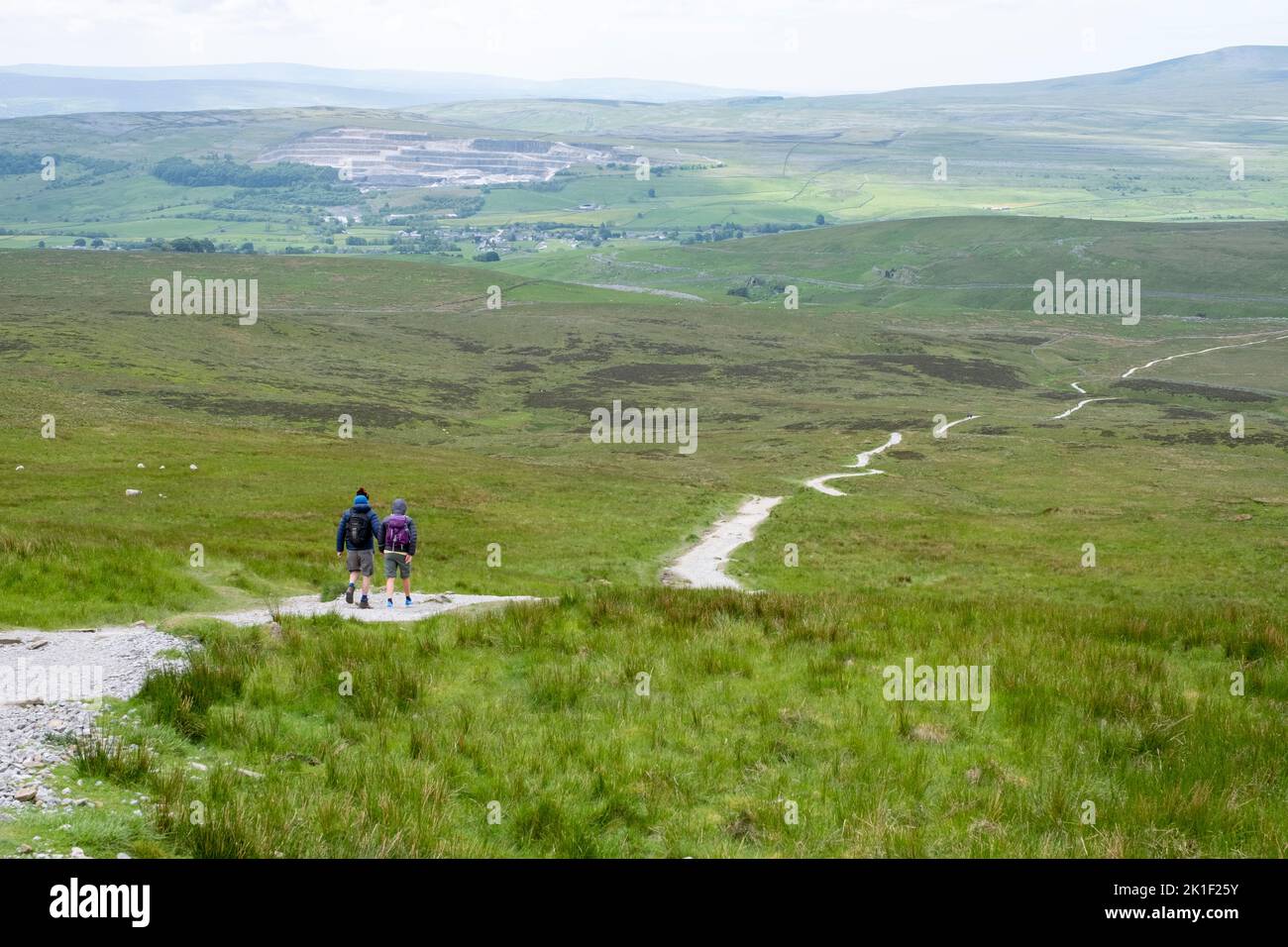 Walkers on the descent from Pen Y Ghent Hill part of The Yorkshire Three Peaks , North Yorkshire, England Stock Photo