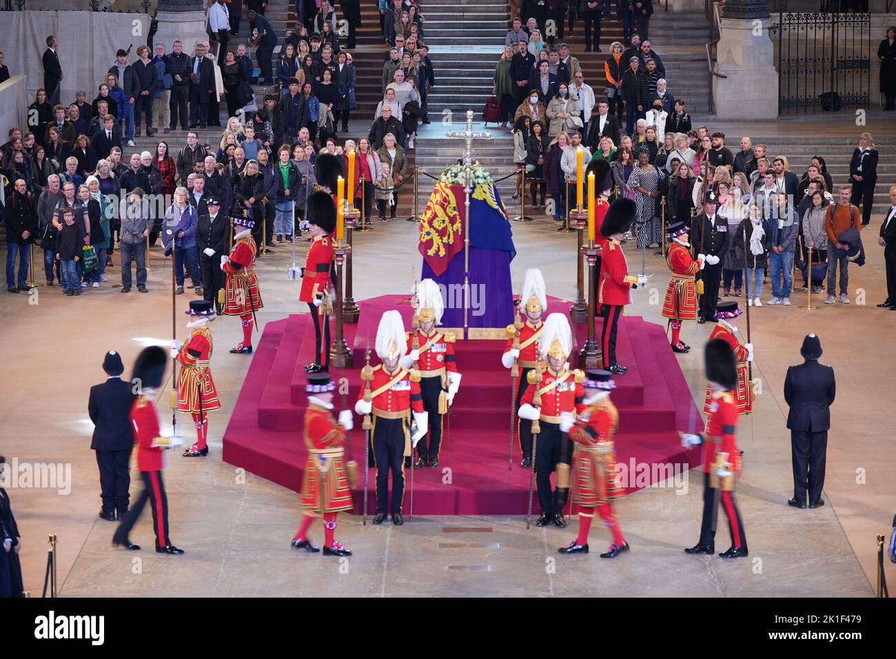 The guard is changed as members of the public file past the coffin of Queen Elizabeth II, draped in the Royal Standard with the Imperial State Crown and the Sovereign's orb and sceptre, lying in state on the catafalque in Westminster Hall, at the Palace of Westminster, London, ahead of her funeral on Monday. Picture date: Sunday September 18, 2022. Stock Photo