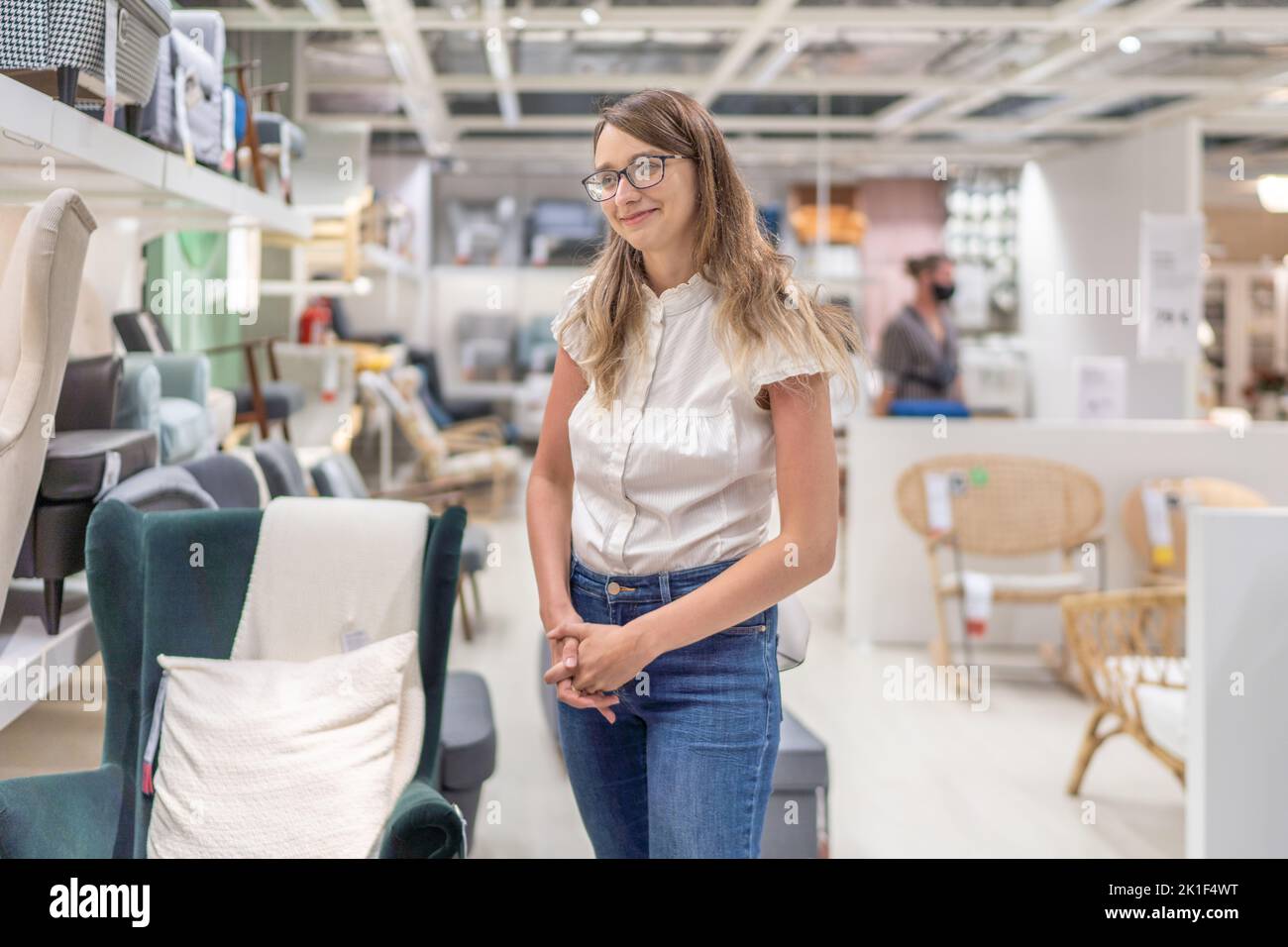 Beautiful Young White Caucasian Girl is in the Department Store Looking