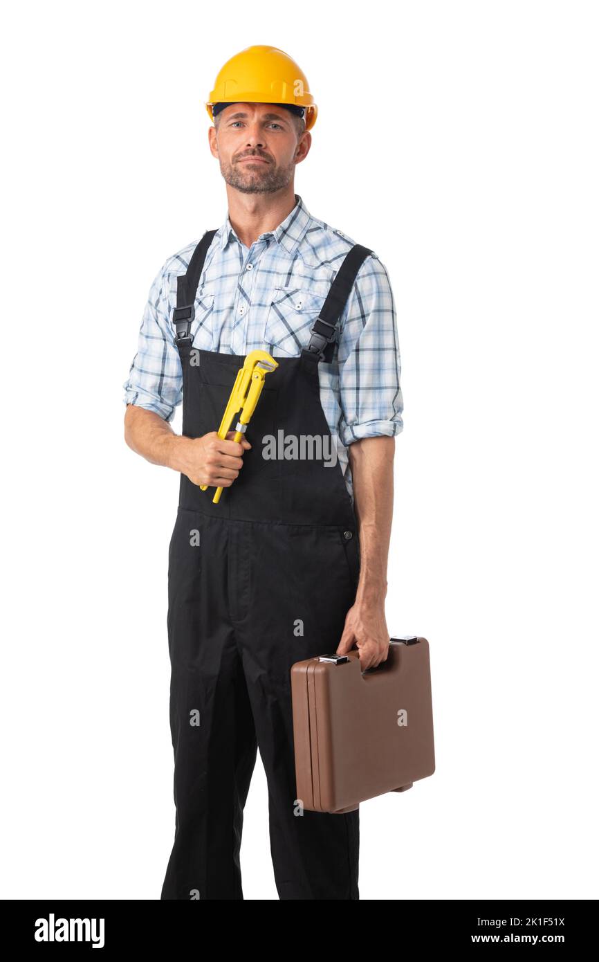 Full length portrait of confident male repairman contractor worker in coveralls holding adjustable spanner and toolbox on white background Stock Photo