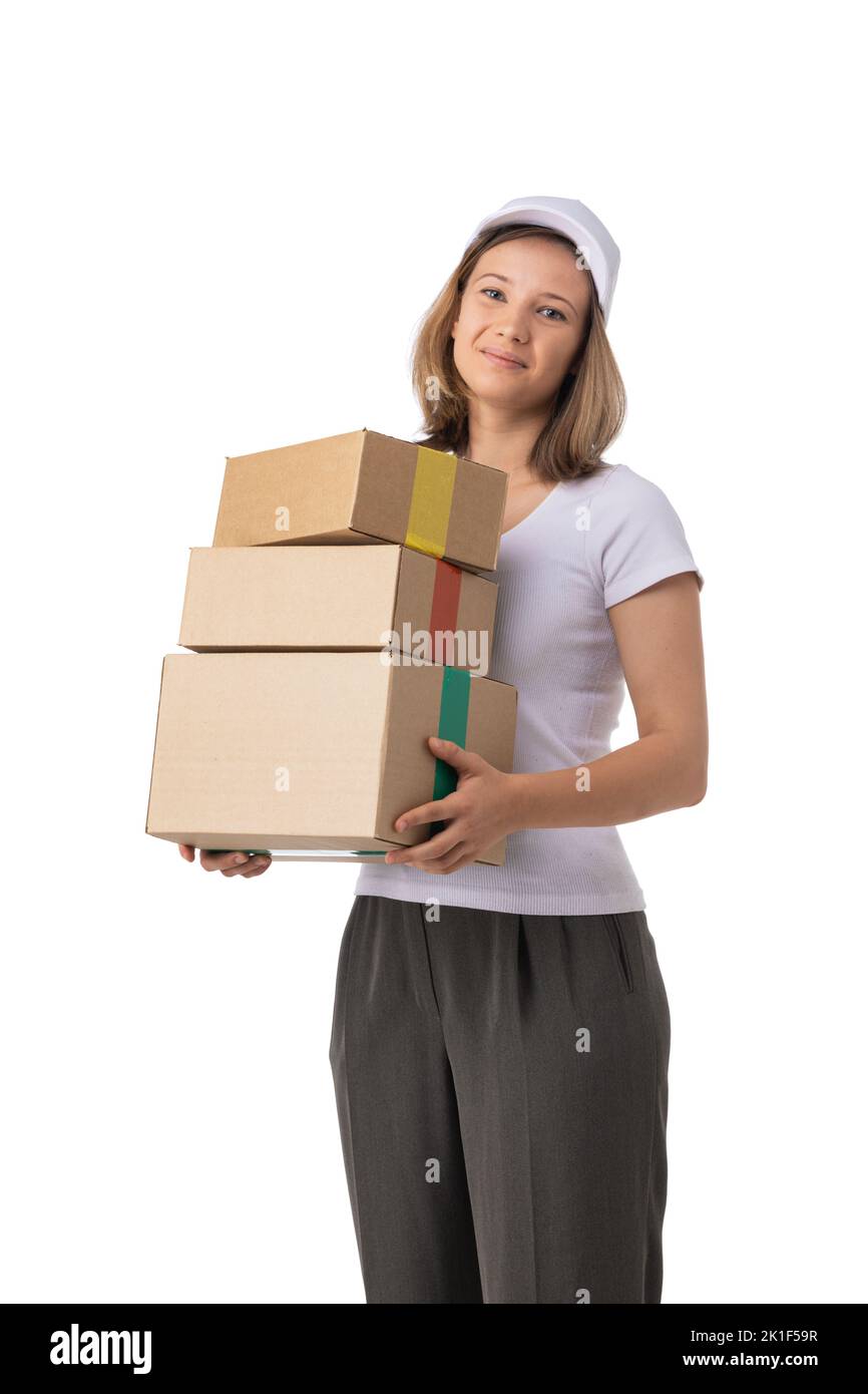 Portrait of delivery woman in white cap, t-shirt giving order boxes isolated on white background. Female courier step, cardboard box. Receiving packag Stock Photo