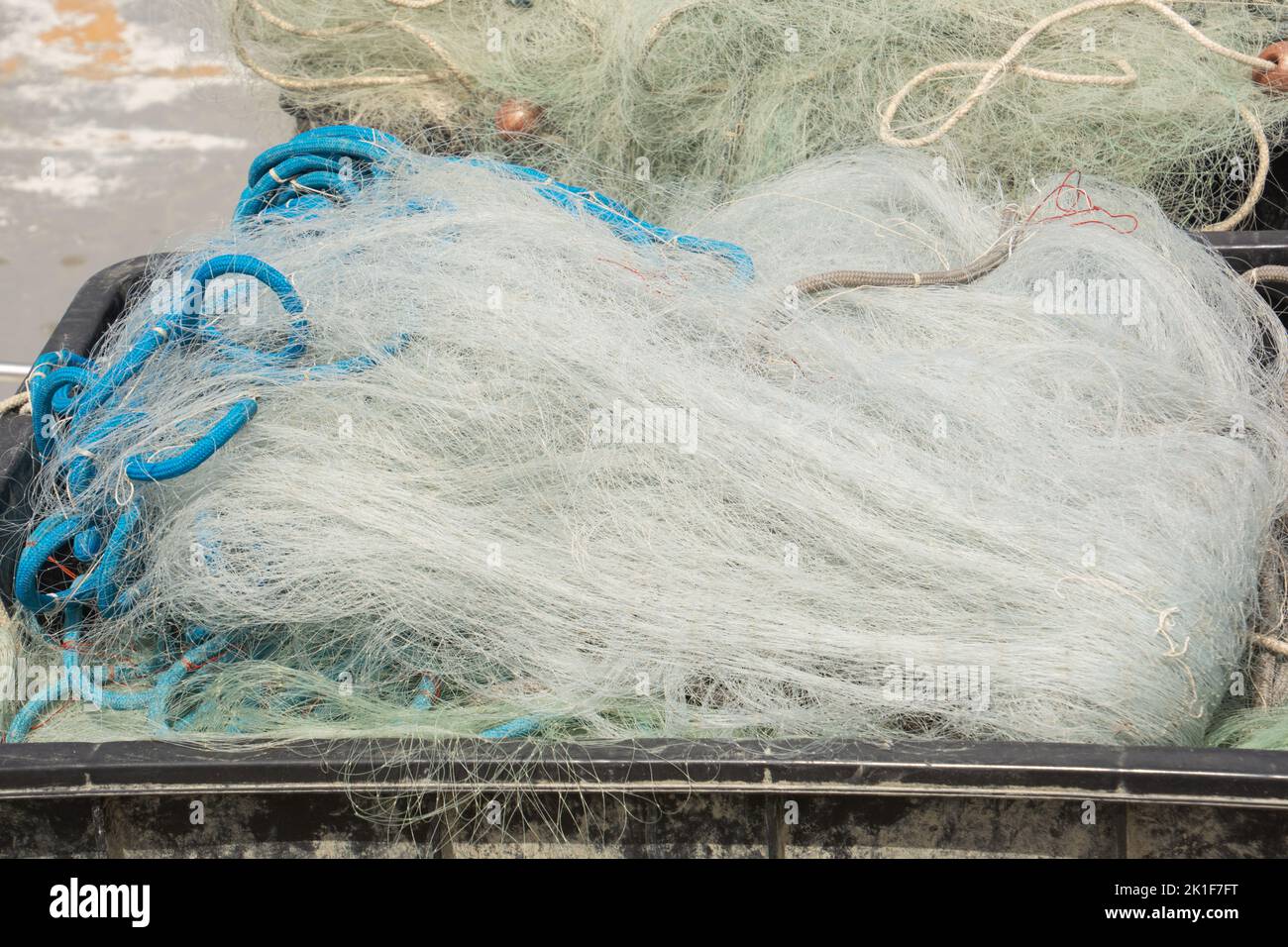 messy fine mesh fishing nets in a pile after use Stock Photo
