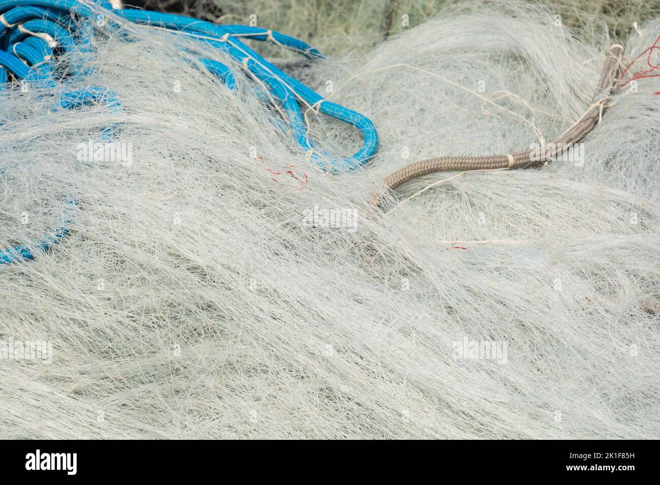 detail view of messy fine mesh fishing nets in a pile after use Stock Photo