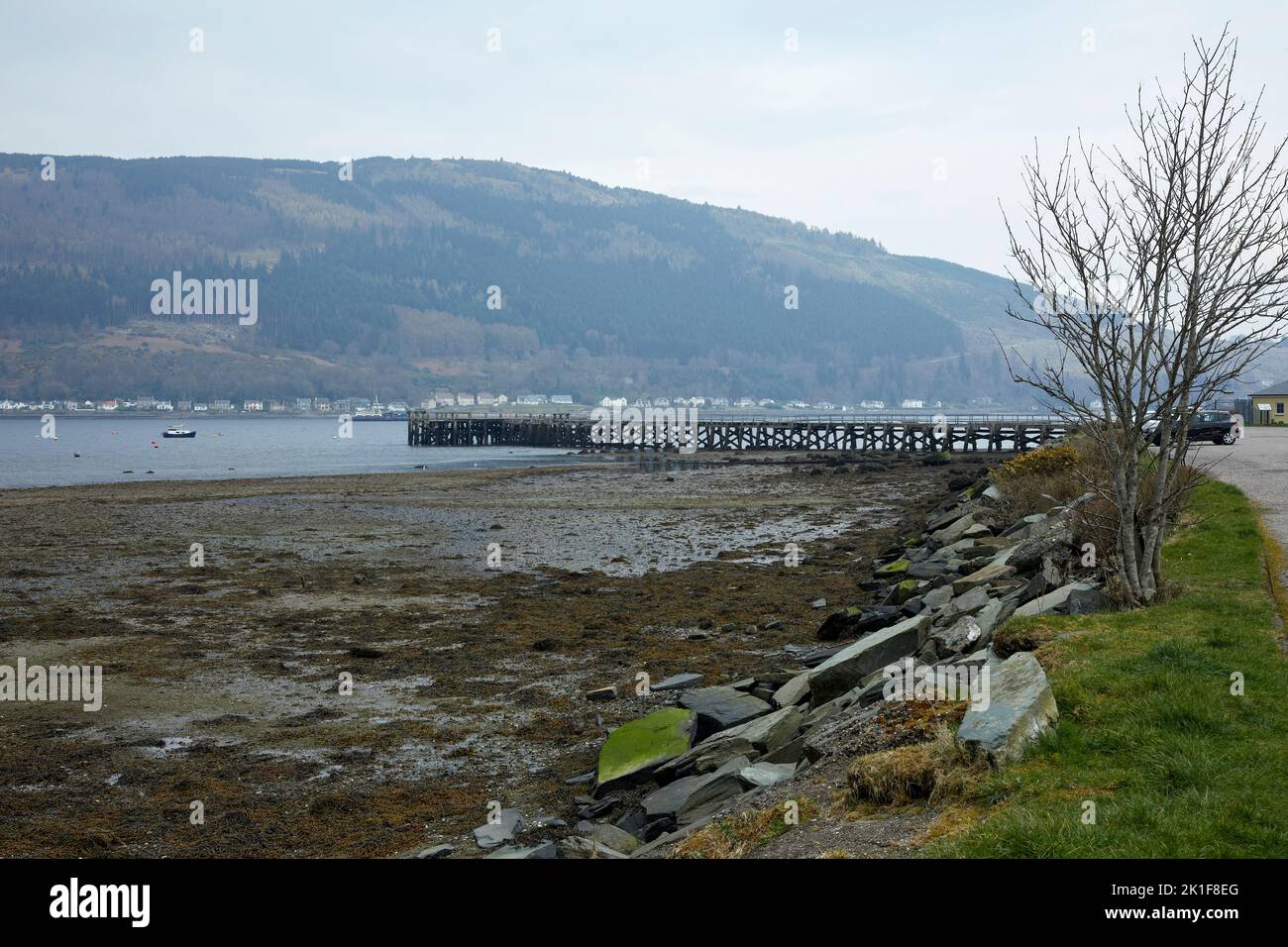 On a hazy late afternoon, the pier at the Dunoon marina protrudes into the Holy Loch. Argyll and Bute Stock Photo