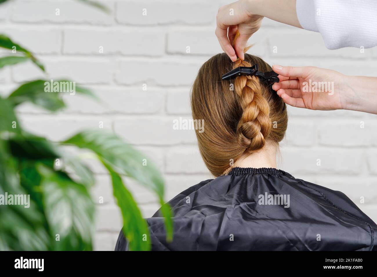 Styling Process Beautiful girl with long hair. creating a hairstyle for unrecognizable ...