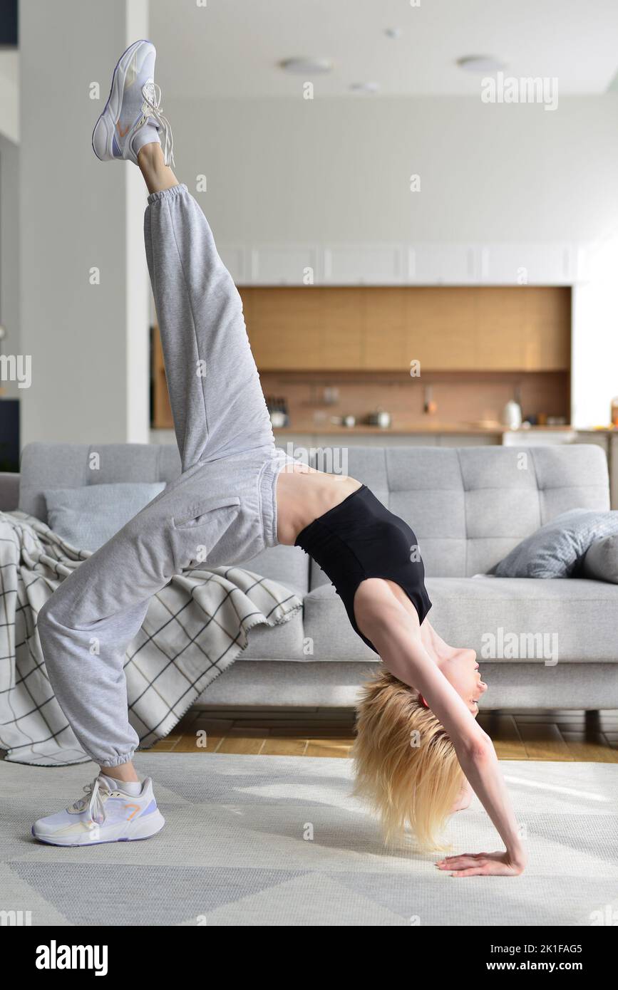 Woman performs bridge exercise at home Stock Photo