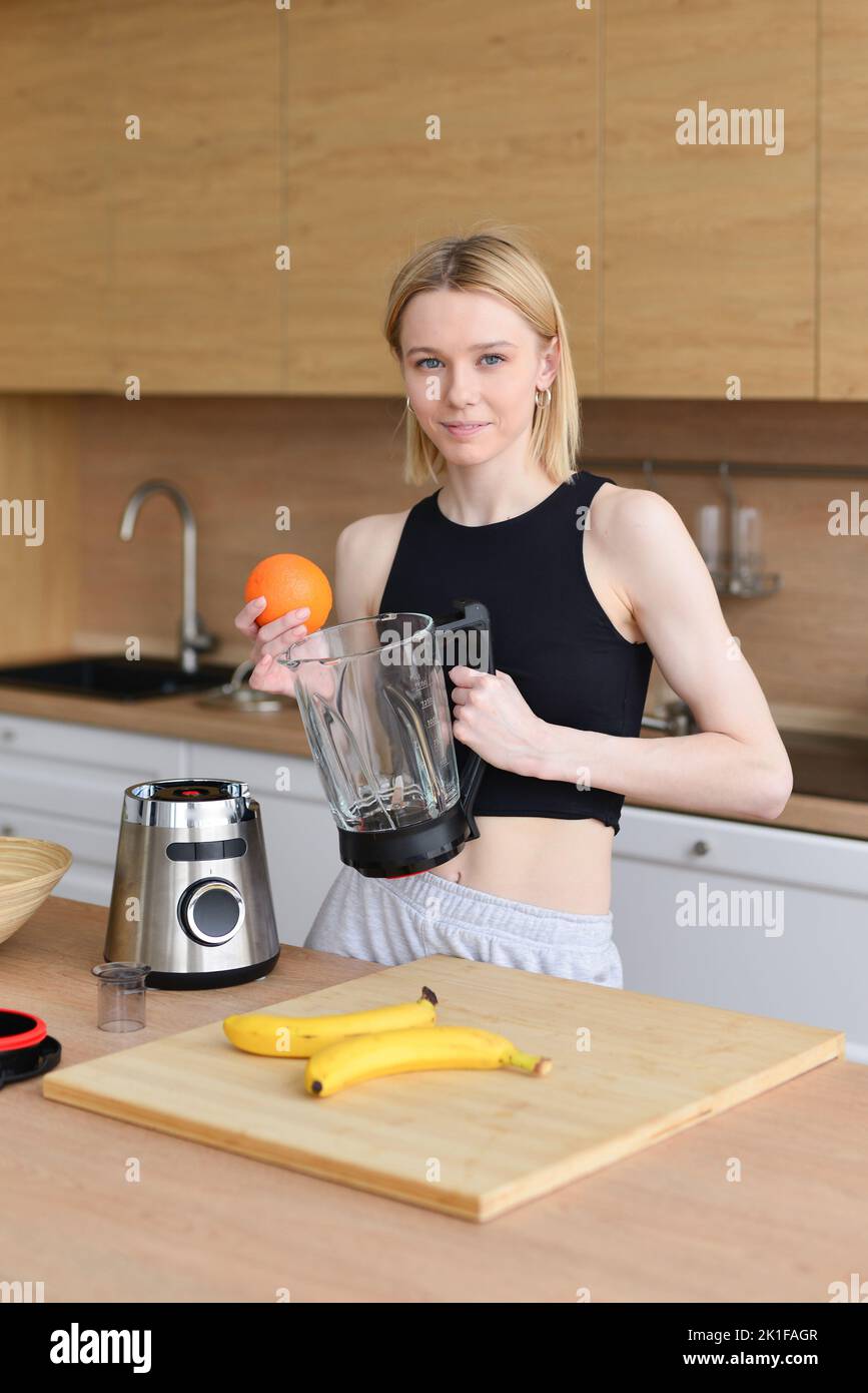 Woman making juice or smoothie. Stock Photo