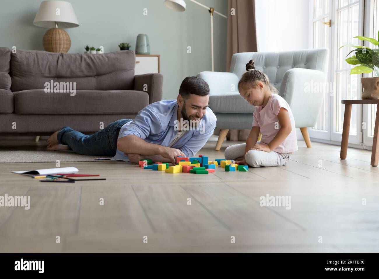 Happy dad and cute little daughter girl playing toy blocks Stock Photo