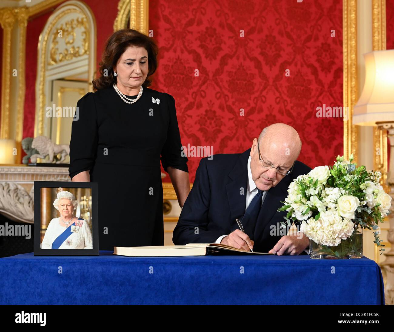 Prime Minister of Lebanon Najib Mikati and his wife May Mikati sign a