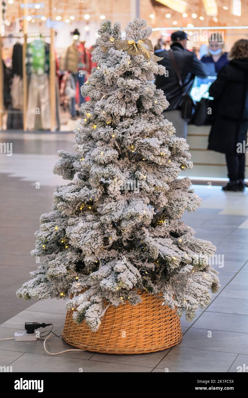 Christmas tree in store in Europea. Christmas decoration prepared for sale in shopping center. Variety of white decoration. Stock Photo