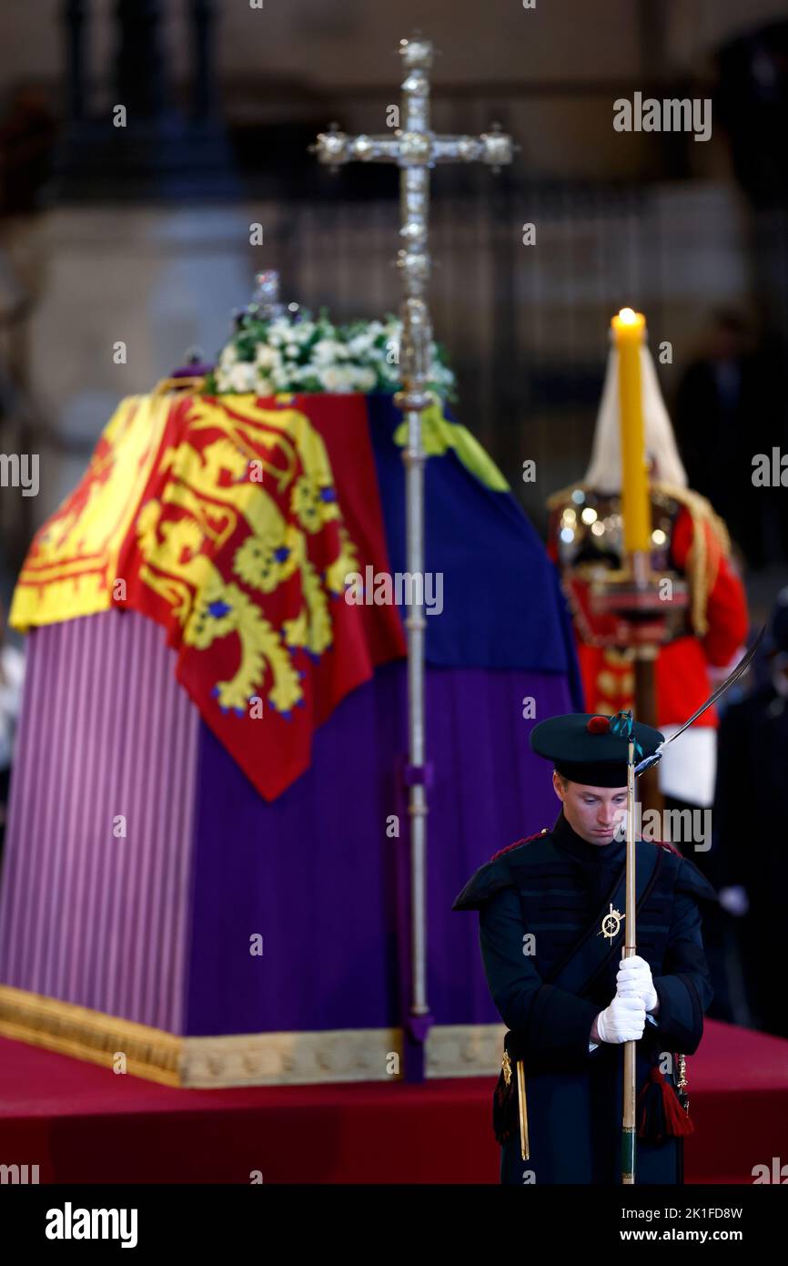 A King's Bodyguard from the Royal Company of Archers stands guard as members of the public view the coffin of Queen Elizabeth II, lying in state on the catafalque in Westminster Hall, at the Palace of Westminster, London, ahead of her funeral on Monday. Picture date: Sunday September 18, 2022. Stock Photo