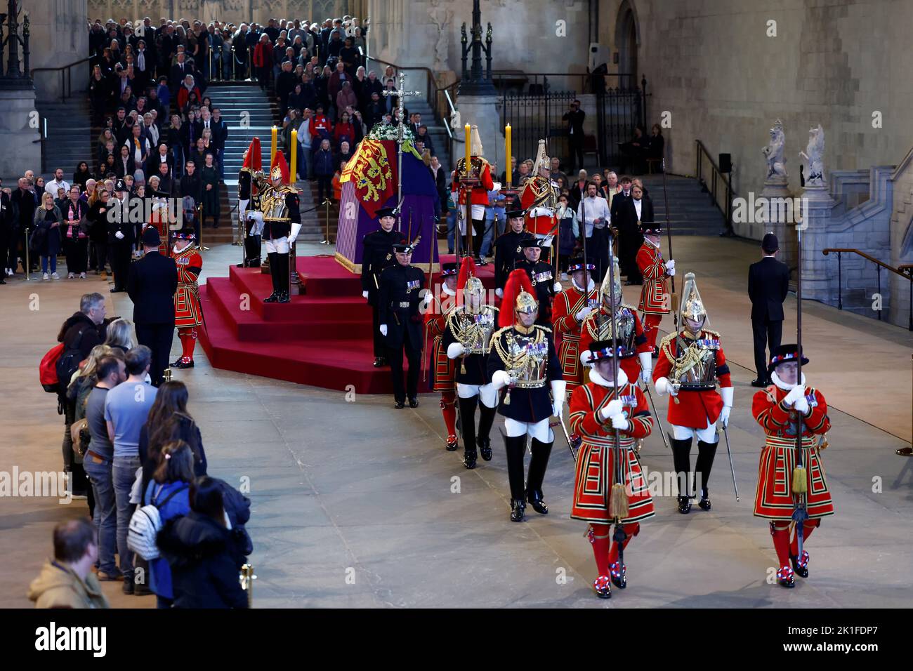 Royal guards change duties as the coffin of Queen Elizabeth II, lies in state on the catafalque in Westminster Hall, at the Palace of Westminster, London, ahead of her funeral on Monday. Picture date: Sunday September 18, 2022. Stock Photo