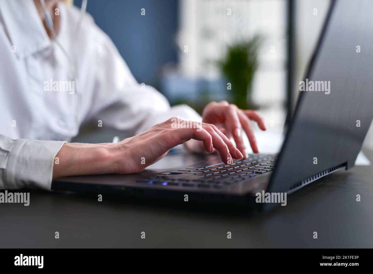 Woman working on her laptop Close-up of hands on keyboard Stock Photo