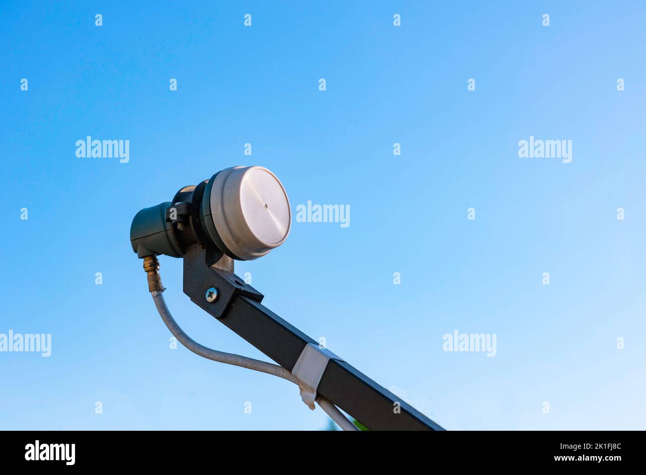 LNB on the feedhorn isolated on blue sky background. Satallite communication background photo. Stock Photo