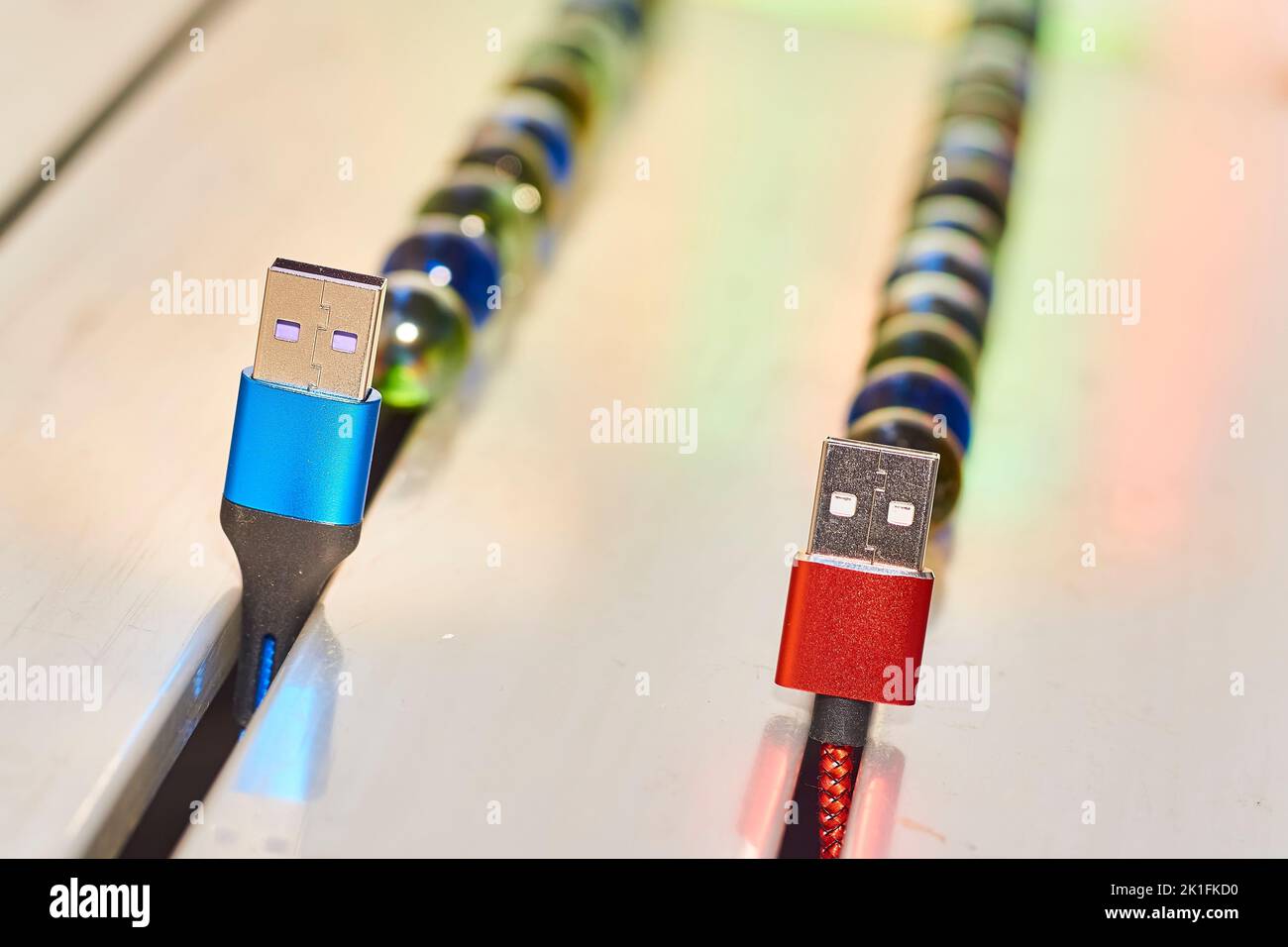 Connect and chat. Blue and red usb cables and colored balloons Stock Photo